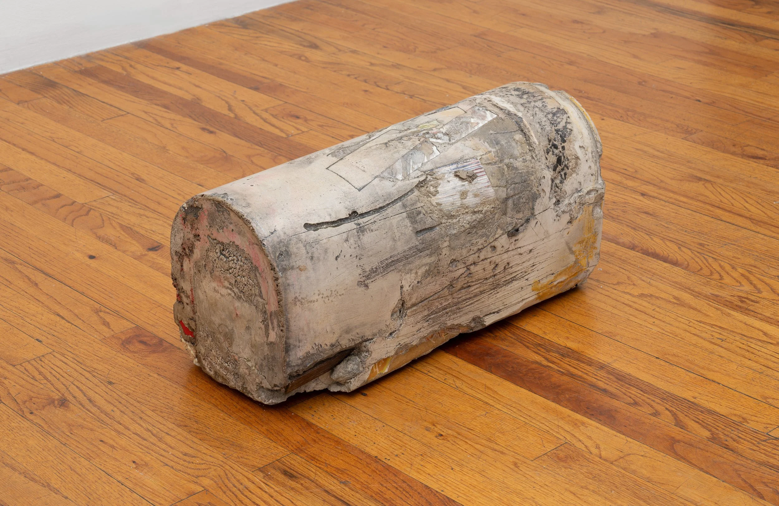  post II, 2025.   Painted hydraulic cement, concrete, embedded TEXAS HISTORY textbook, wood, paper, detritus   9 ½ × 8 × 21 in (24.13 × 20.32 × 53.34 cm)   47 Canal   