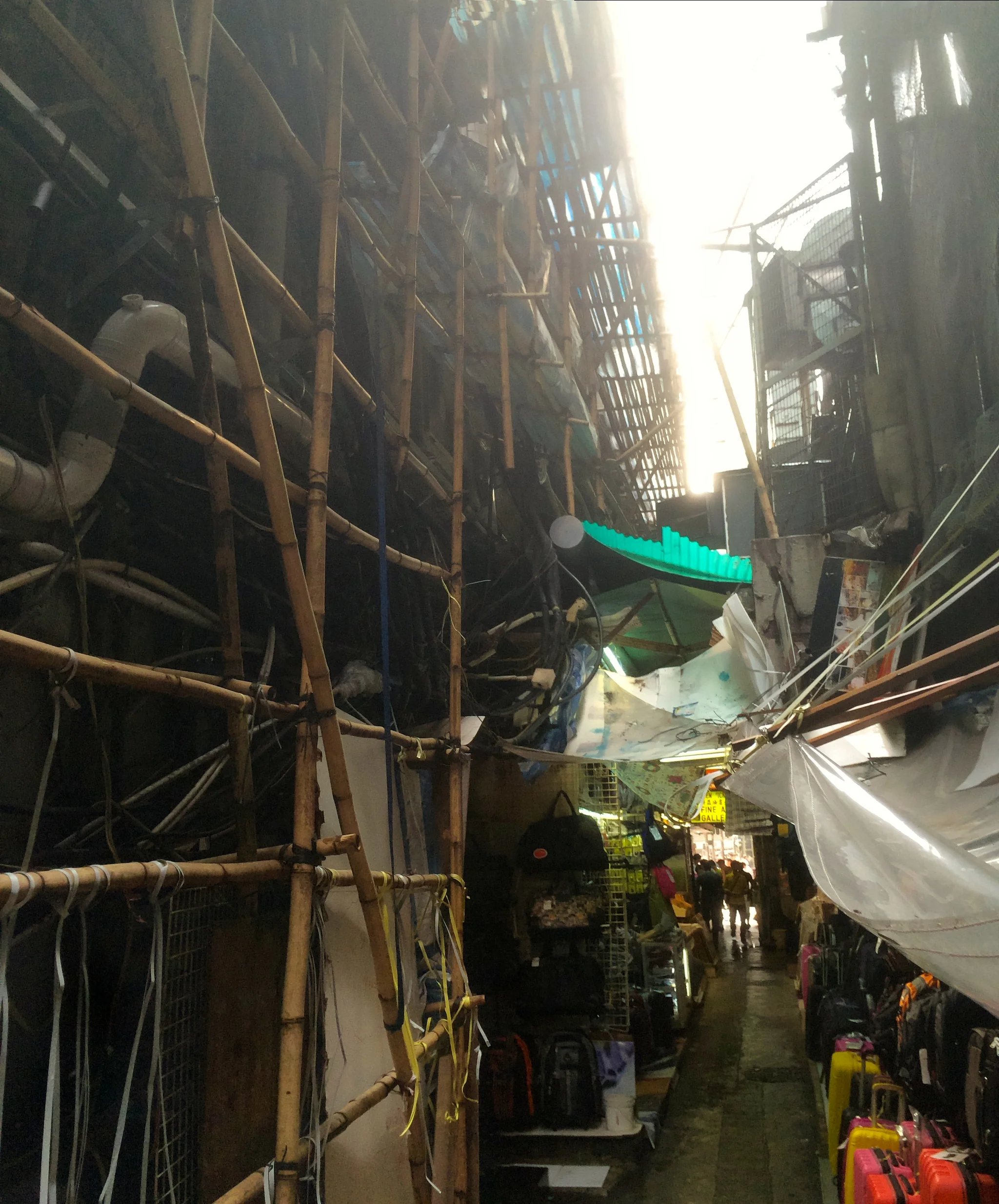 we decided to walk down this alley...and discovered this....a rats nest of bamboo scaffolding, tarps, and poorly rigged electrical wires. creepy, yes....and kinda cool.