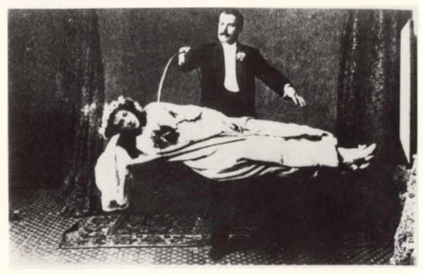 David Devant levitating a woman.