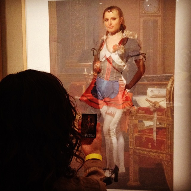 a museum goer ponders and photographs the piece selected for Neptune.