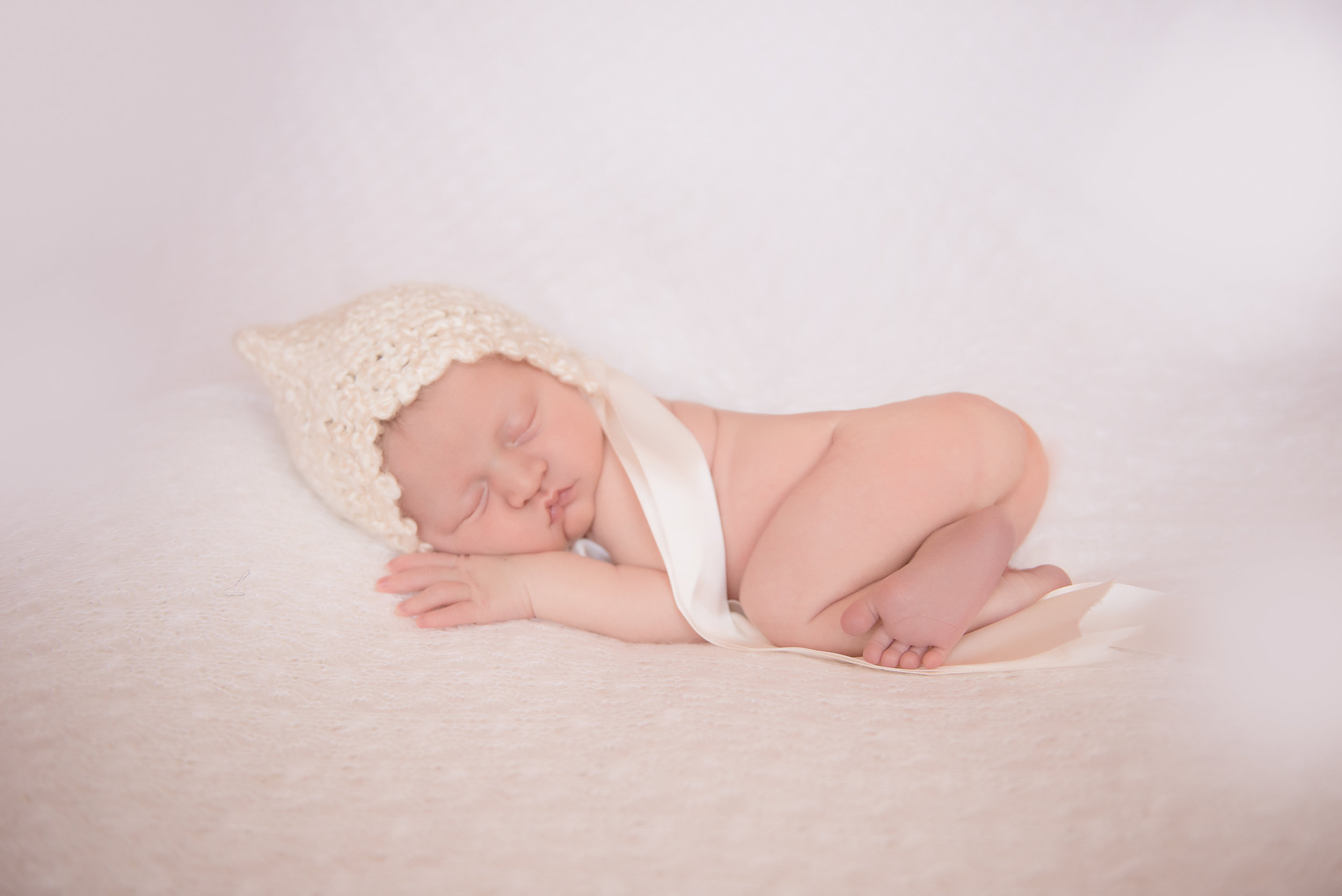 newborn girl in bonnet