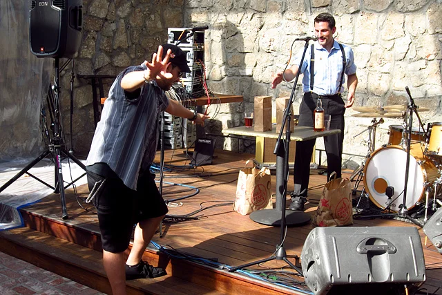  Allan Katz assists Joshua with a magic trick he's never performed onstage before.​ 