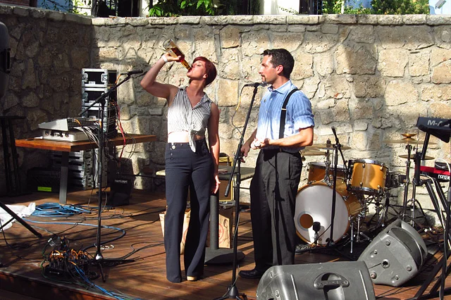  Karen Grill "assists" Joshua with his bottle of Sailor Jerry.​ 