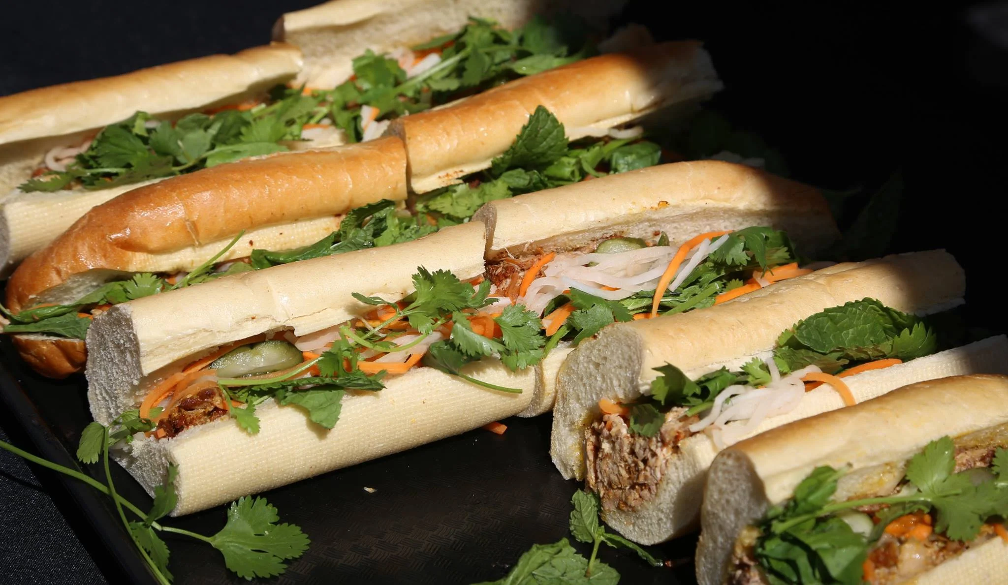 Just a few weeks before he opened Here's Looking At You, Chef Jonathan Whitener graciously donated and served roasted pork banh mi at ABTG V | Photo by Eugene Lee