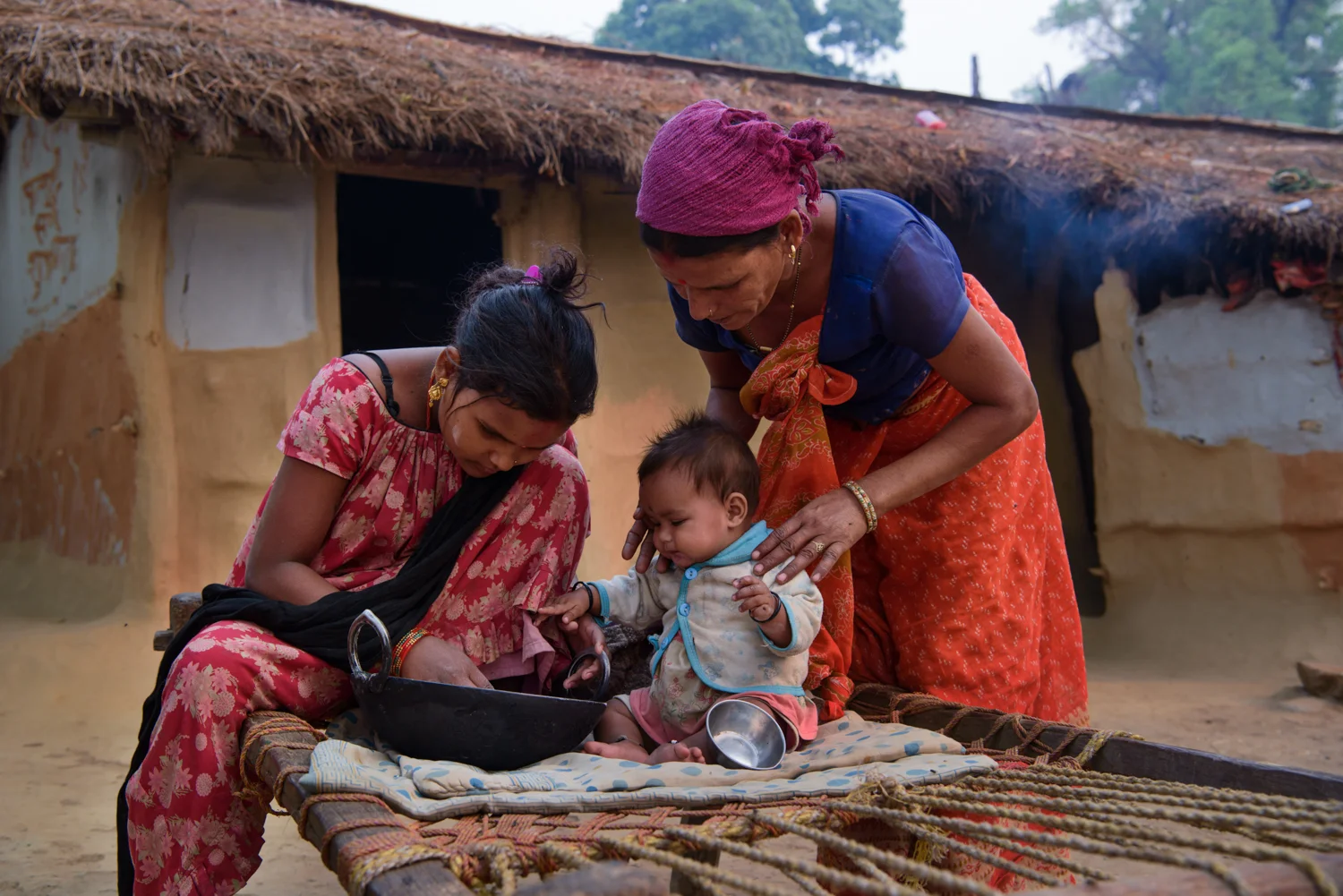 Lalita Badi (17) with her mother and seven month old daughter Ritu at their home in Majhi Shivir, Chaumala, Kailali, Nepal. Lalita had an arranged marriage at the age of 12 with an older man. She got pregnant soon and then lost her two babies one after another. Lalita's husband left her a year ago and married another woman and keeps no contact with her.