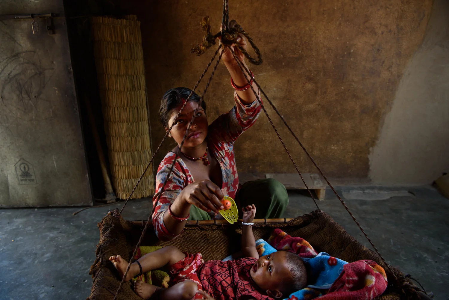 Sarita Majhi (17) with her five months old daughter Sumita at her home in Malpur Village, Chitwan, Nepal. Sarita says she was not interested in studies and left education after class 7. She eloped and married Shiva (20) who works as a labourer in Delhi.