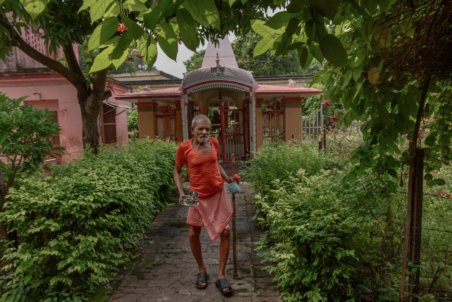 Rajnarayan Ashram, 80, in front of a temple near the men's accomodation section of the Mumukshu Bhawan in Varanasi.