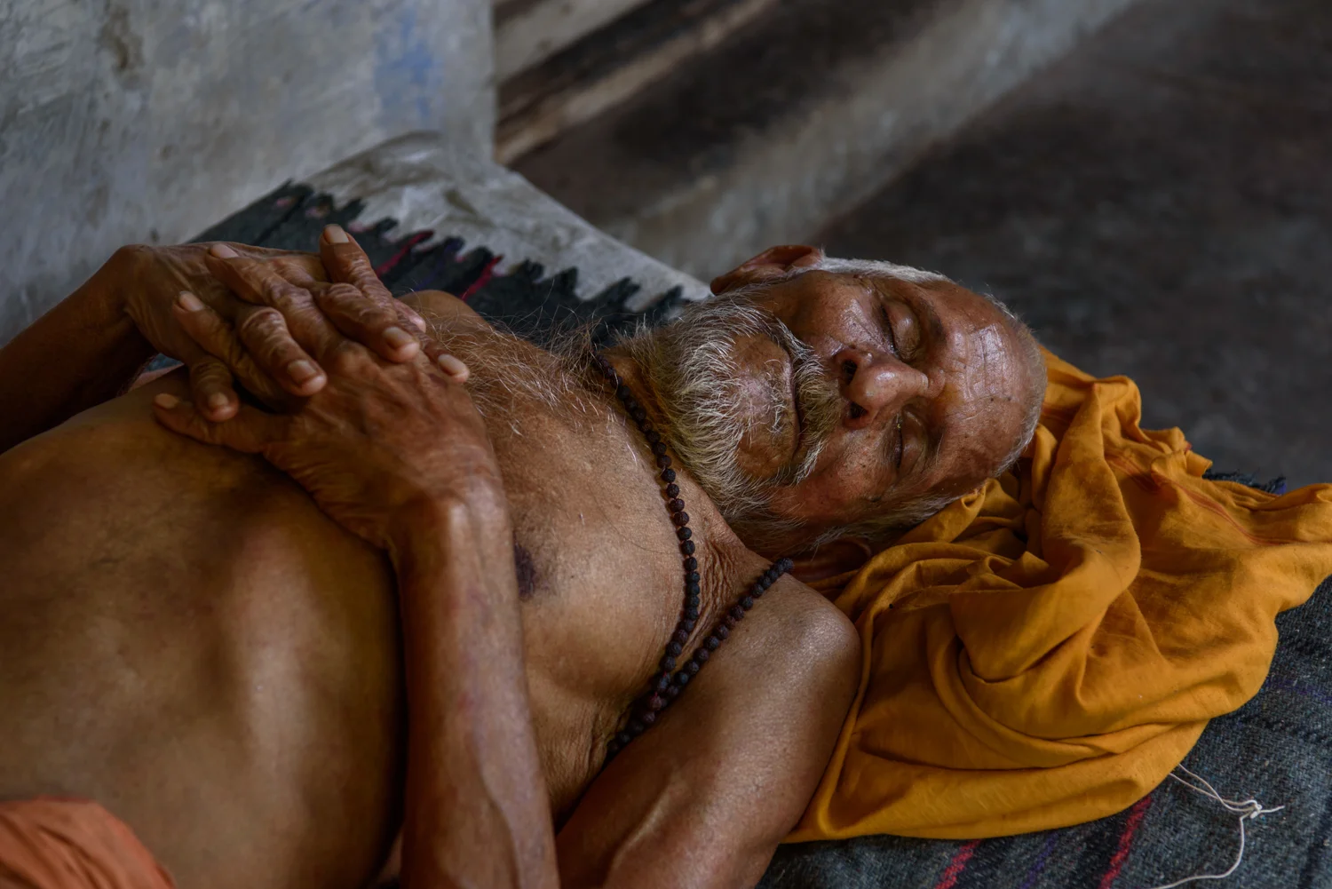 A sadhu takes an afternoon siesta at the men's accomodation section of Mumukshu Bhawan in Varanasi.
