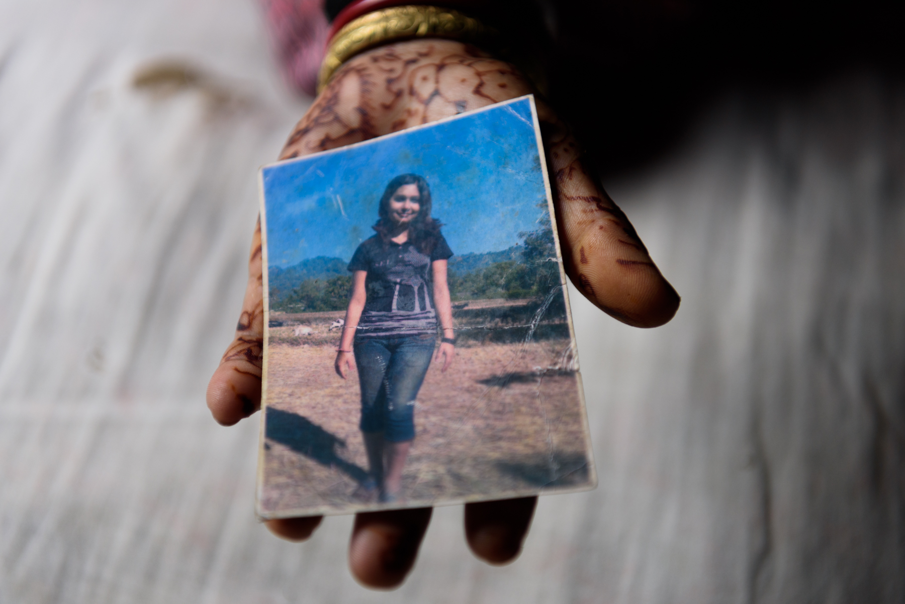  Sunita Biswakarma, 40, shows the photograph of her daughter Ranjana. Ranjana, 16, has been missing since 2009. She was trafficked by her uncle while travelling with him for a family wedding. Except for a birth certificate and a photograph, there is 