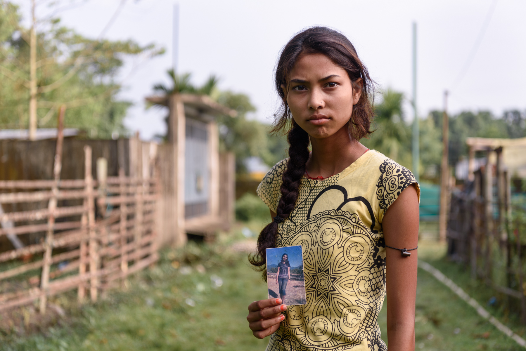  Binita Biswakarma, 15, with a photograph of her sister Ranjana. Ranjana, 16, has been missing since 2009. She was trafficked by her uncle while travelling with him for a family wedding. Binita's parents are illiterate and never filed a police report