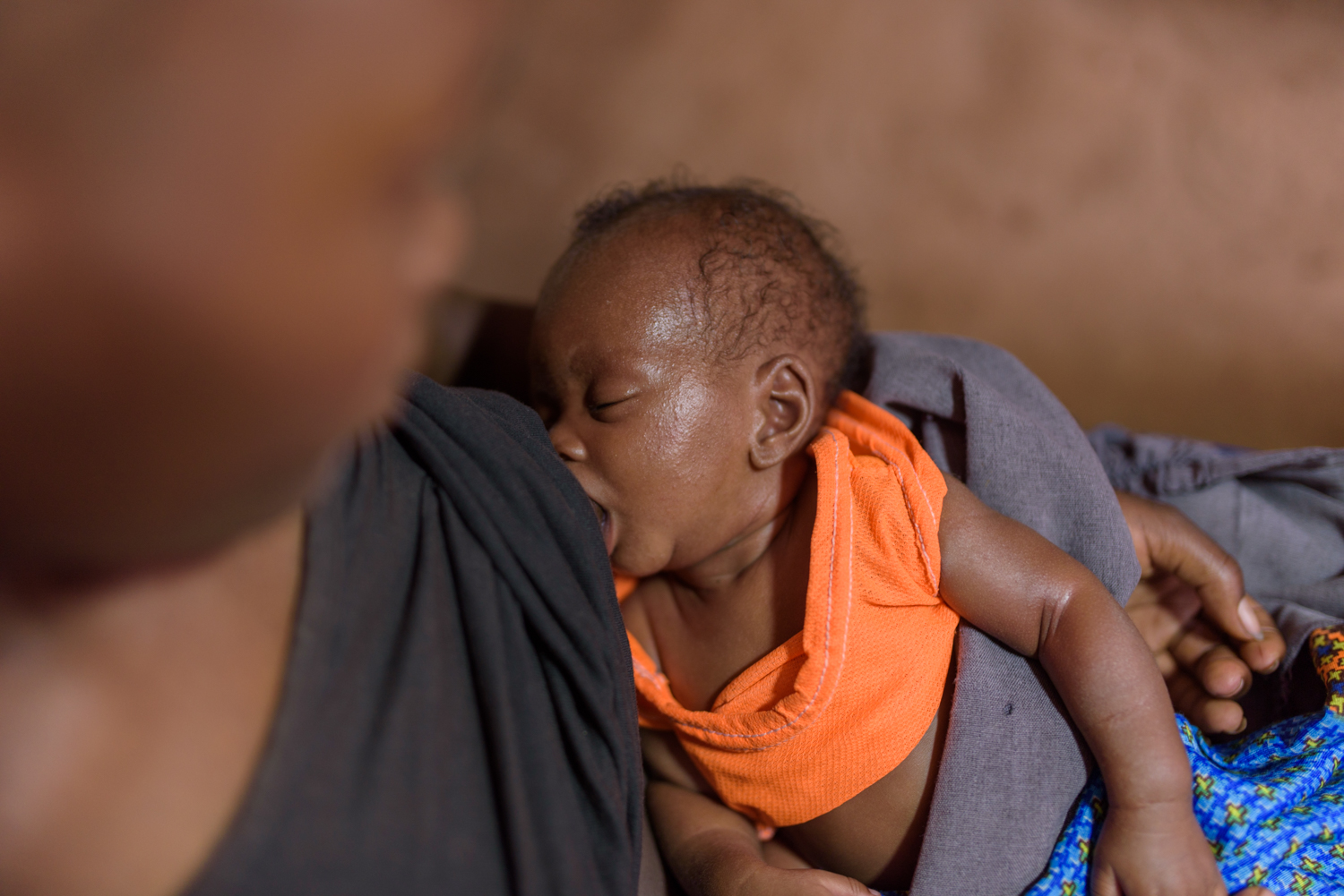  D. R., 16, with her two month old son at her home in Migori County. D. currently studies at the Ngukumahando Primary School and runs home everyday during lunch break to breastfeed her newborn. 