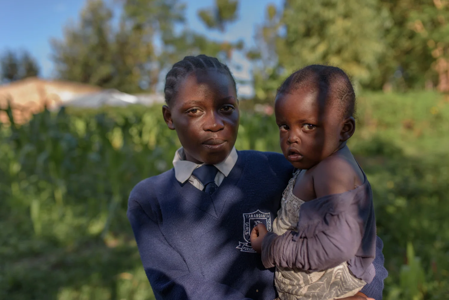 T.R., 17, with her three year old daughter G. at her home in Migori County. T. met a boy three years ago and ended up getting pregnant. She discovered her pregnancy when she was giving Primary School Examination. Her boyfriend deserted her but her grandmother supported her and took her to the hospital for delivery.