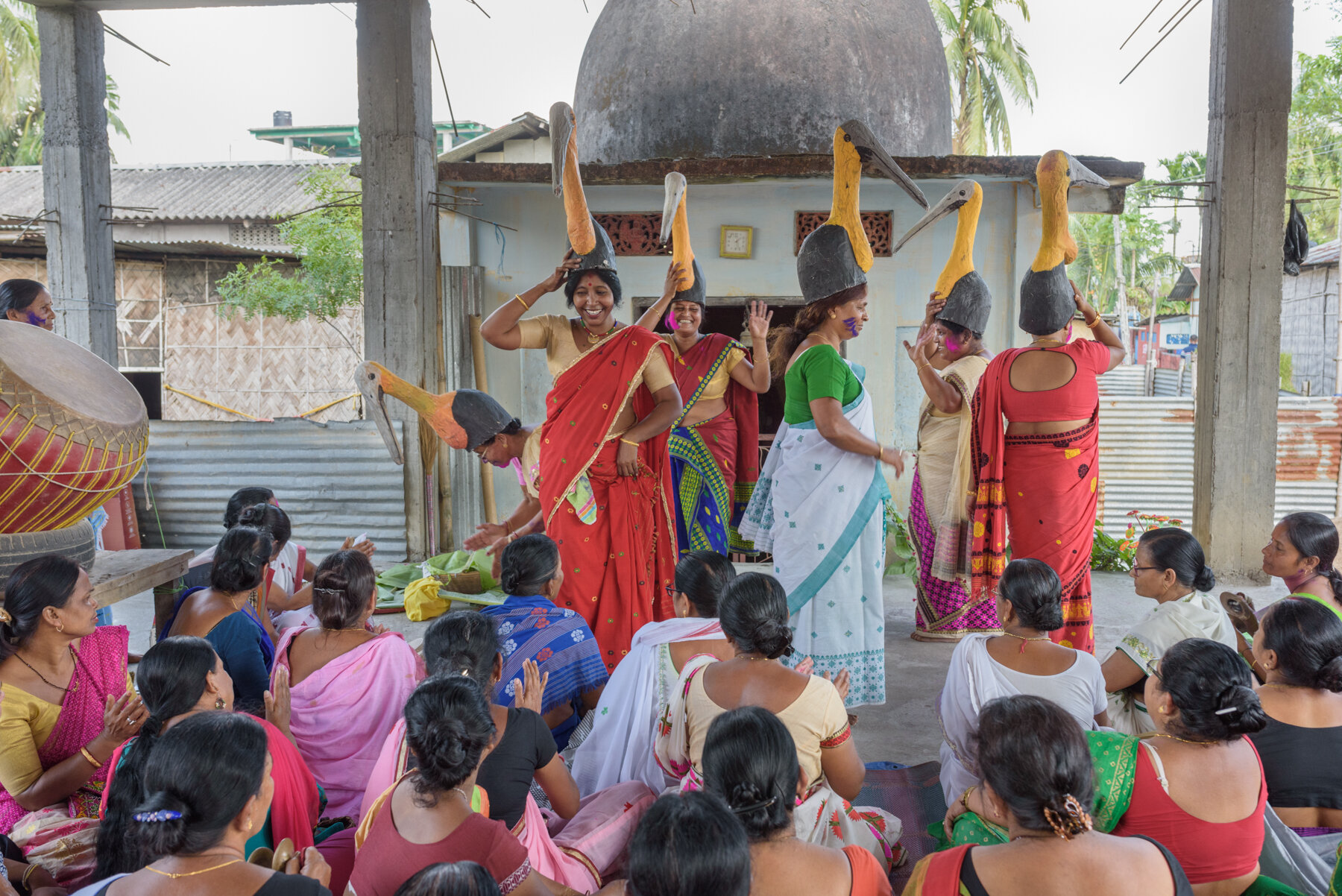  Members of the all-women Hargila Army dance wearing stork masks while some sing traditional songs at the baby shower for the greater adjutant storks at Dadara village, Assam, India. The baby shower according to the Assamese tradition is observed for
