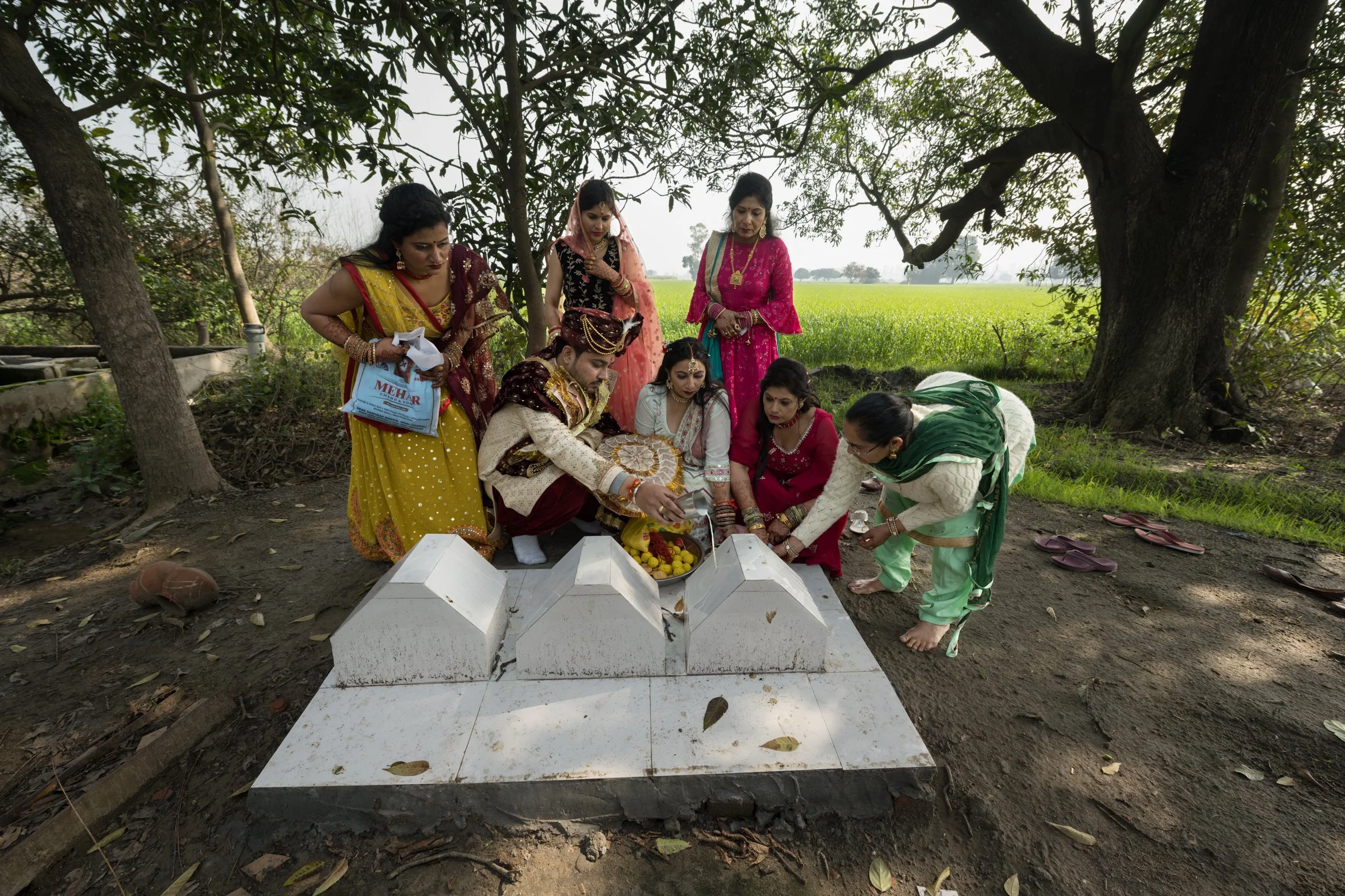 Groom Abhisek Gandhi accompanied by relatives seek blessings from an altar of their forefathers, located at their ancestral farm near Badarpur village, Karnal region, Haryana. Abhisek is the nephew of farmer Rajesh Kumar. Rajesh is a fourth generati