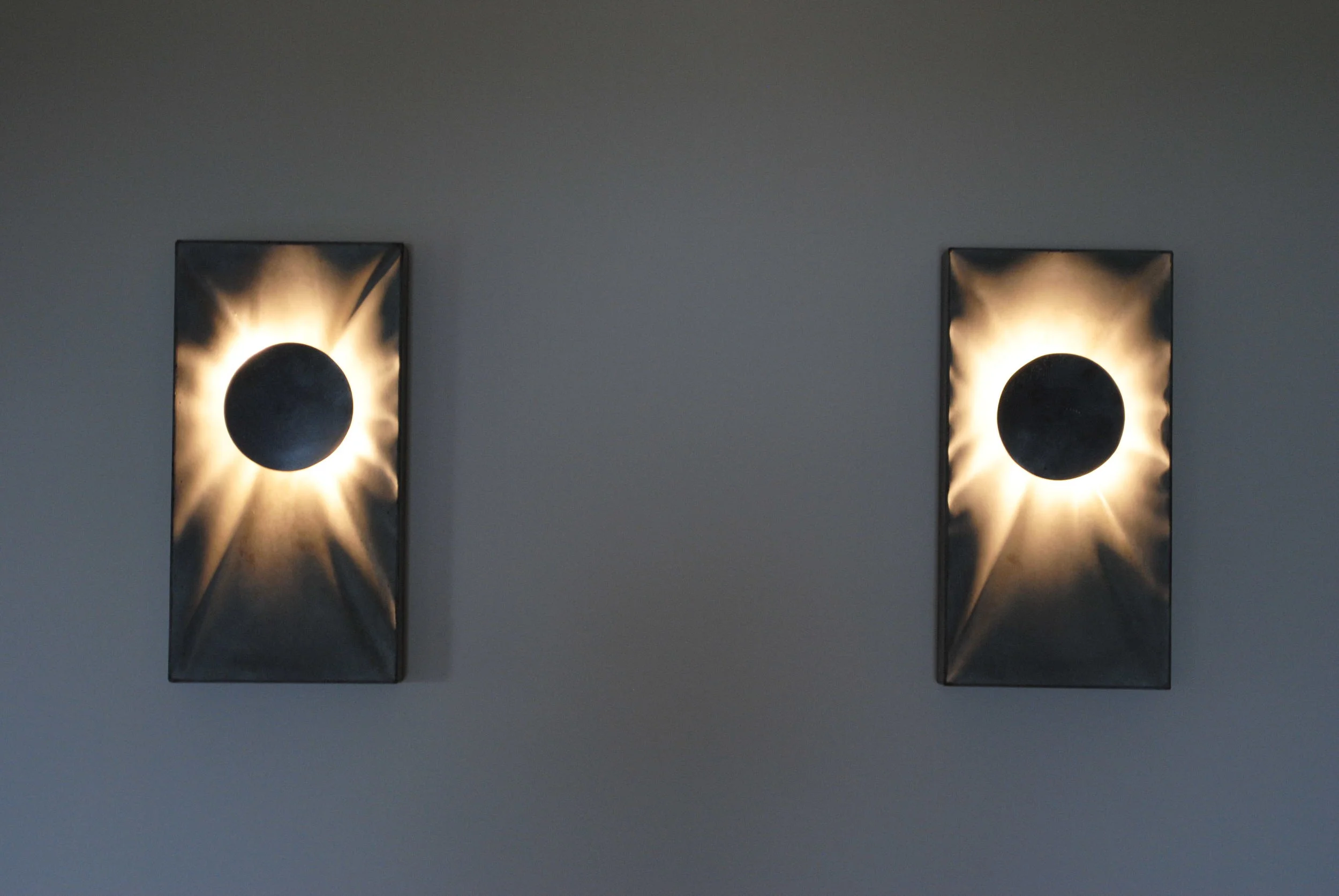  The Eclipse sconce, available in gray and white and custom colors. &nbsp;Gray/white model: $230&nbsp;add $50 for custom color. &nbsp;GFRC concrete with round steel diffuser 7"x13 5/8"x2" 