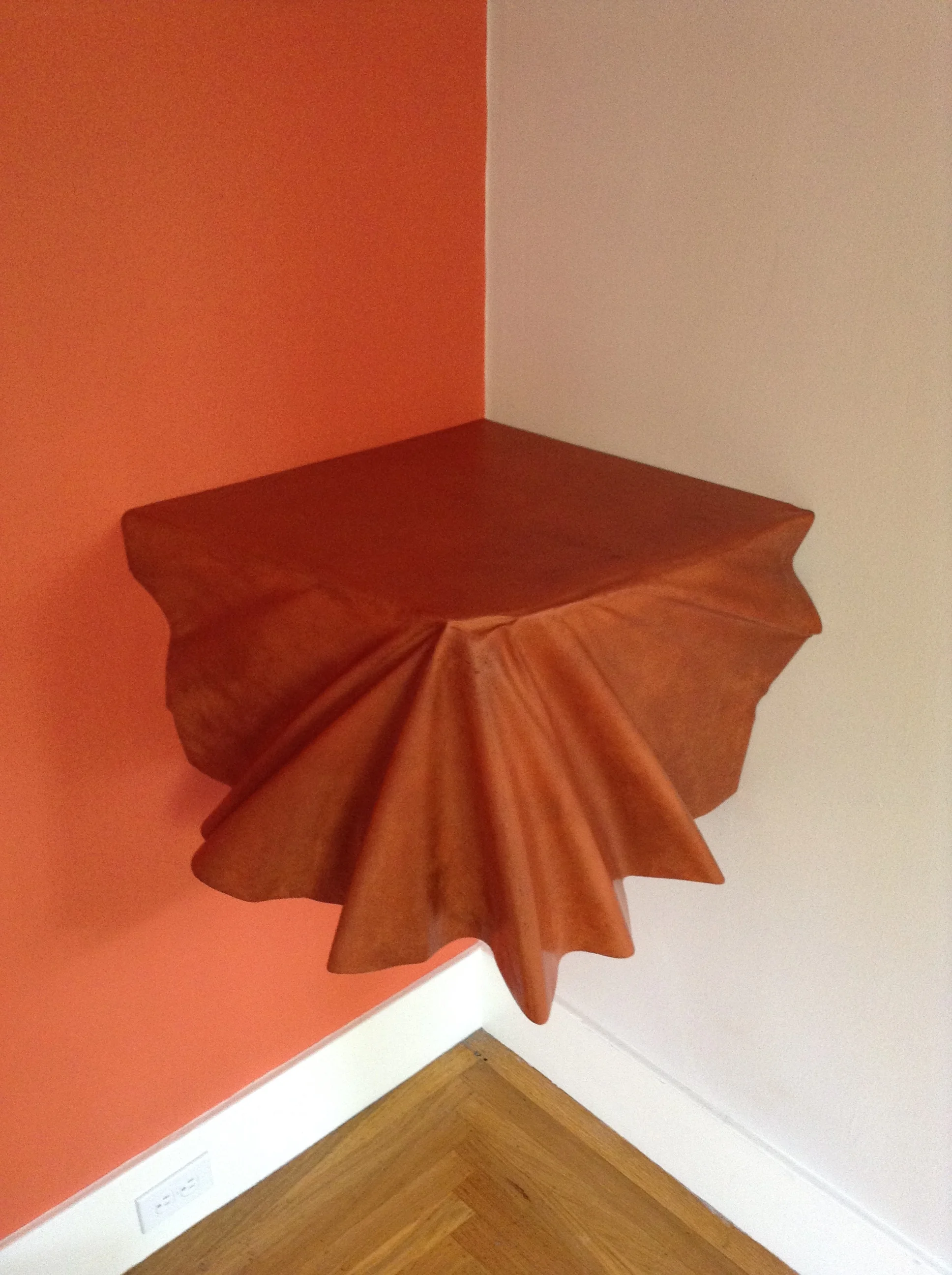 Draped corner shelf in Brick color. This shelf created a focal point out of an empty corner and brought a whole new dimension to the room.