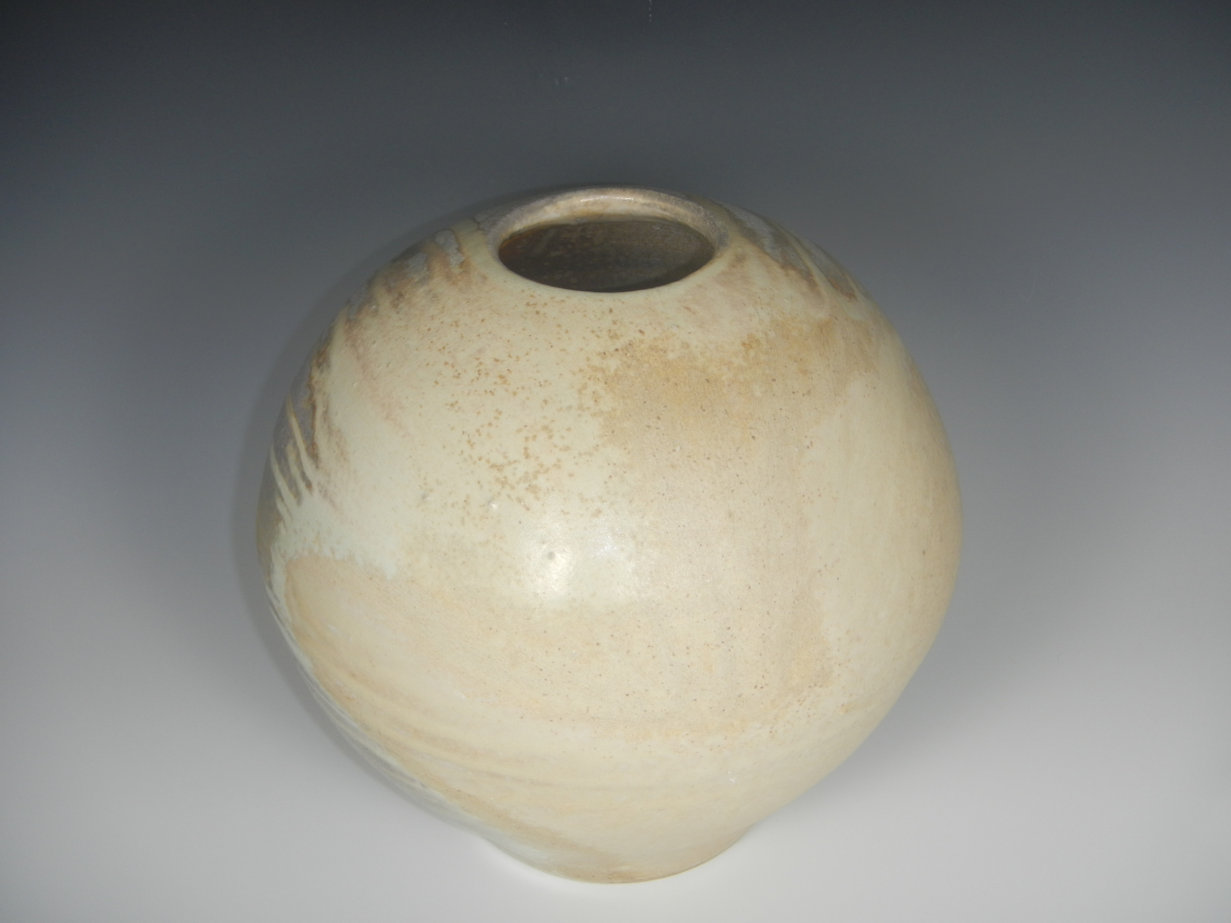 (Jack Troy vessel. The ash in the firing settled upon this side of the vessel, which faced up during firing as the pot lay on its side; the ash made a semi-smooth surface with areas of feldspar-like glistening texture and variations in the cream colors. Photo Mimi Stadler 2014)