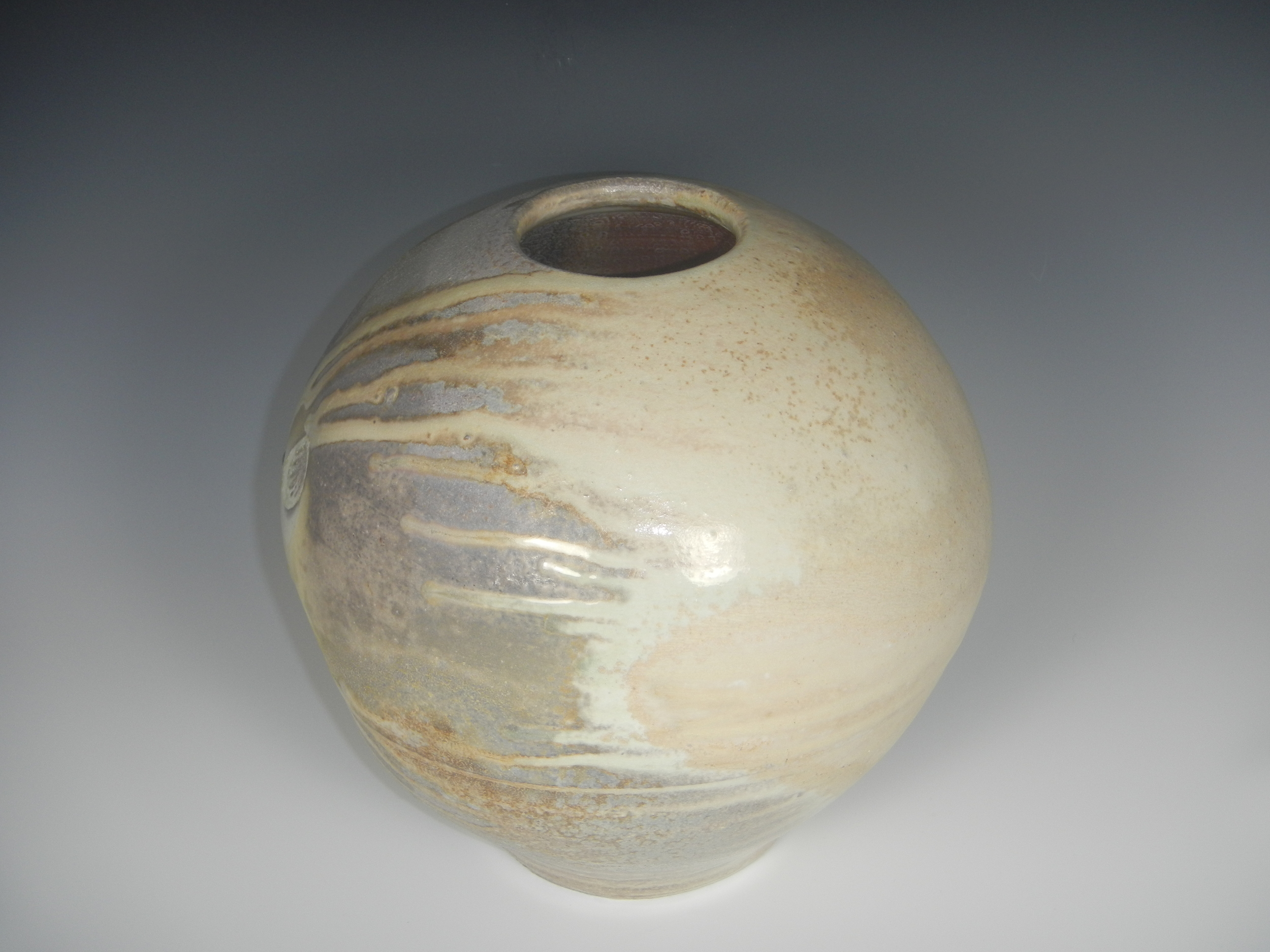 (The melted ash flowed in many smaller runs off of the cream colored side of the pot, which was facing up in the kiln. Photo Mimi Stadler 2014) 