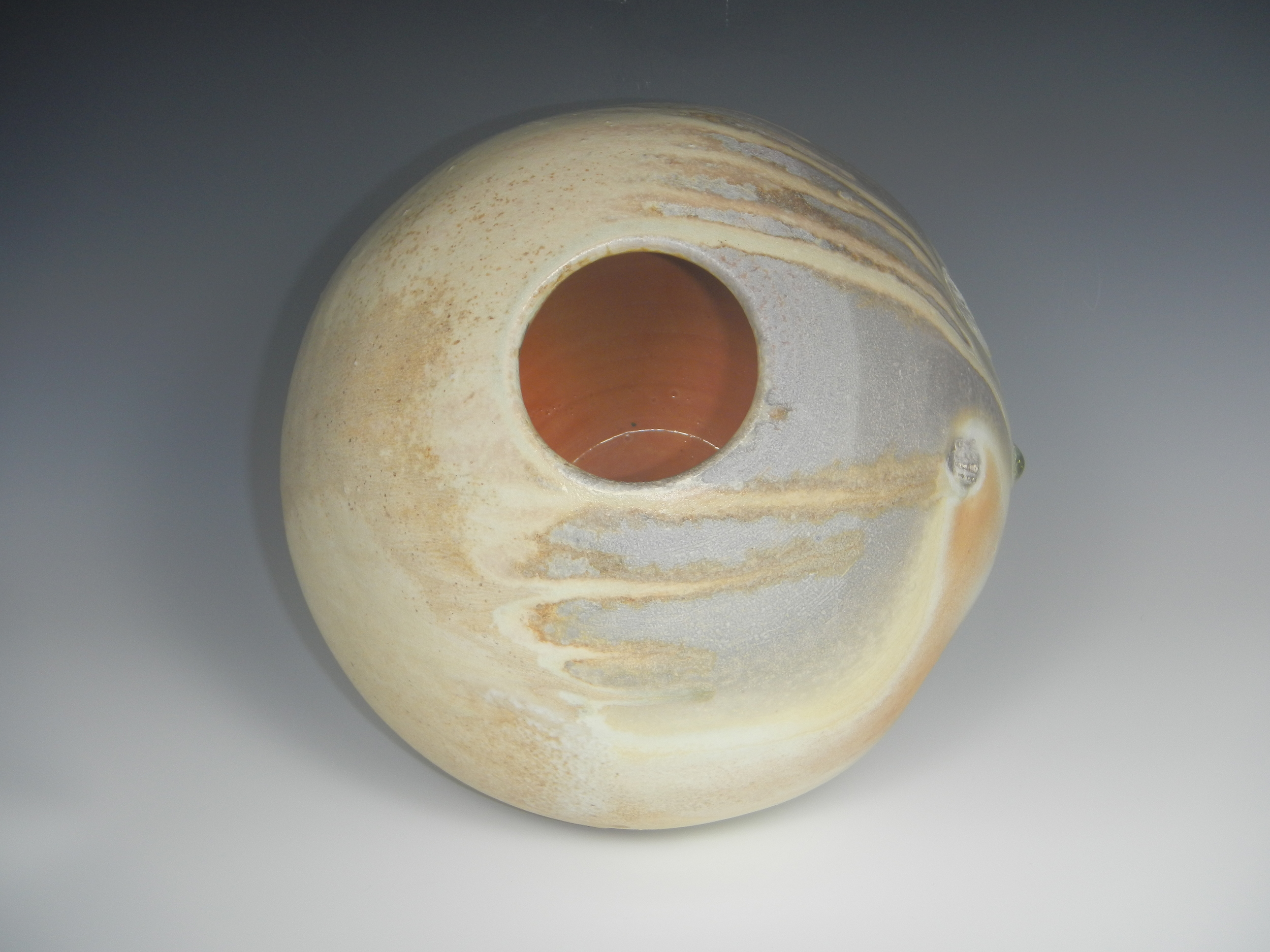 (Although this vessel is all about the rotund body, it is still a vessel, with an interior and an exterior. The interior is a lovely surprise. Mr. Troy used a Malcolm Davis shino glaze with Redart clay added to it. The result radiates visual warmth. Photo Mimi Stadler 2014)