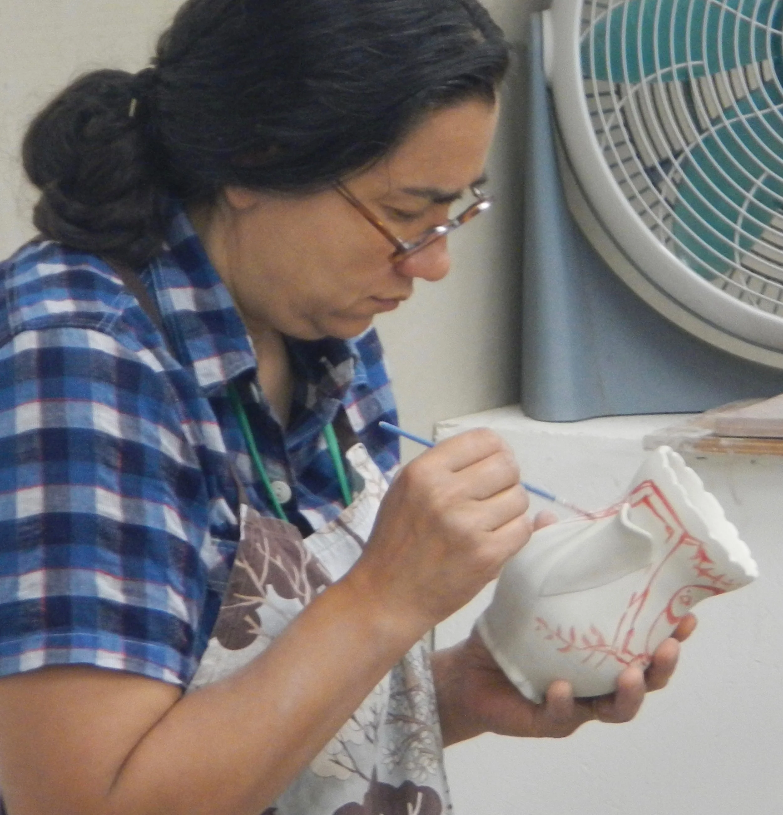 (Ayumi applying luster (like the lustered bird in the previous photo) over a glaze-fired white pot)