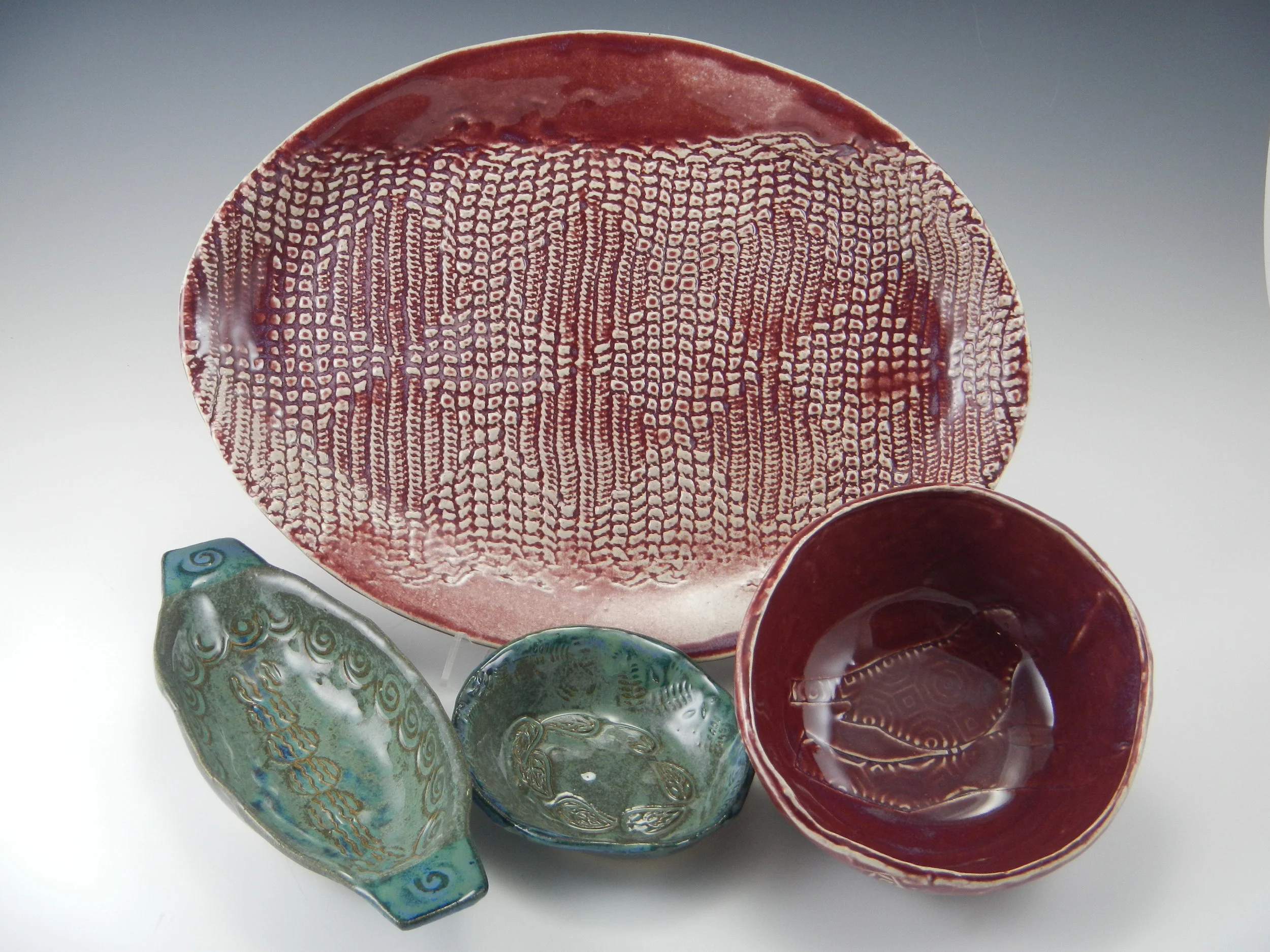 (Lace, stamps, and various great textures on dining and serving pieces)