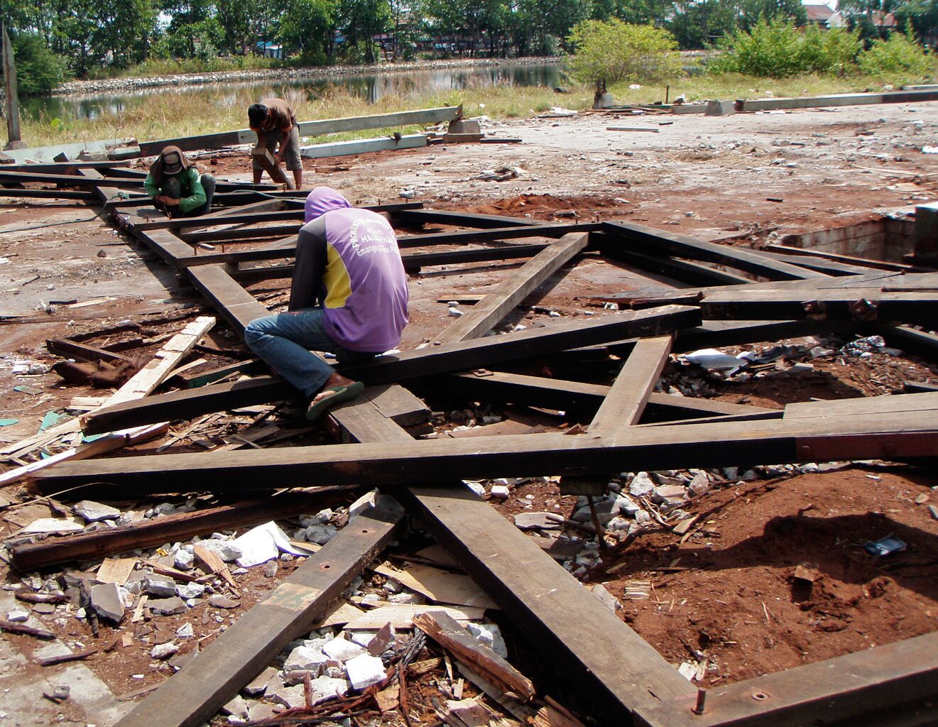  Workers dismantle Ironwood trusses from a defunct sawmill to salvage the wood for our Rose Mix flooring 