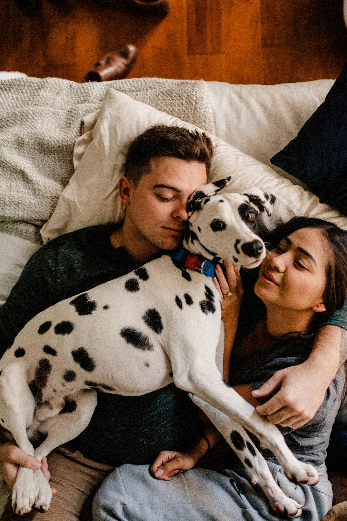  Jared, Olivia & their fur baby Chip the Dalmatian laying around for their in-home session! 