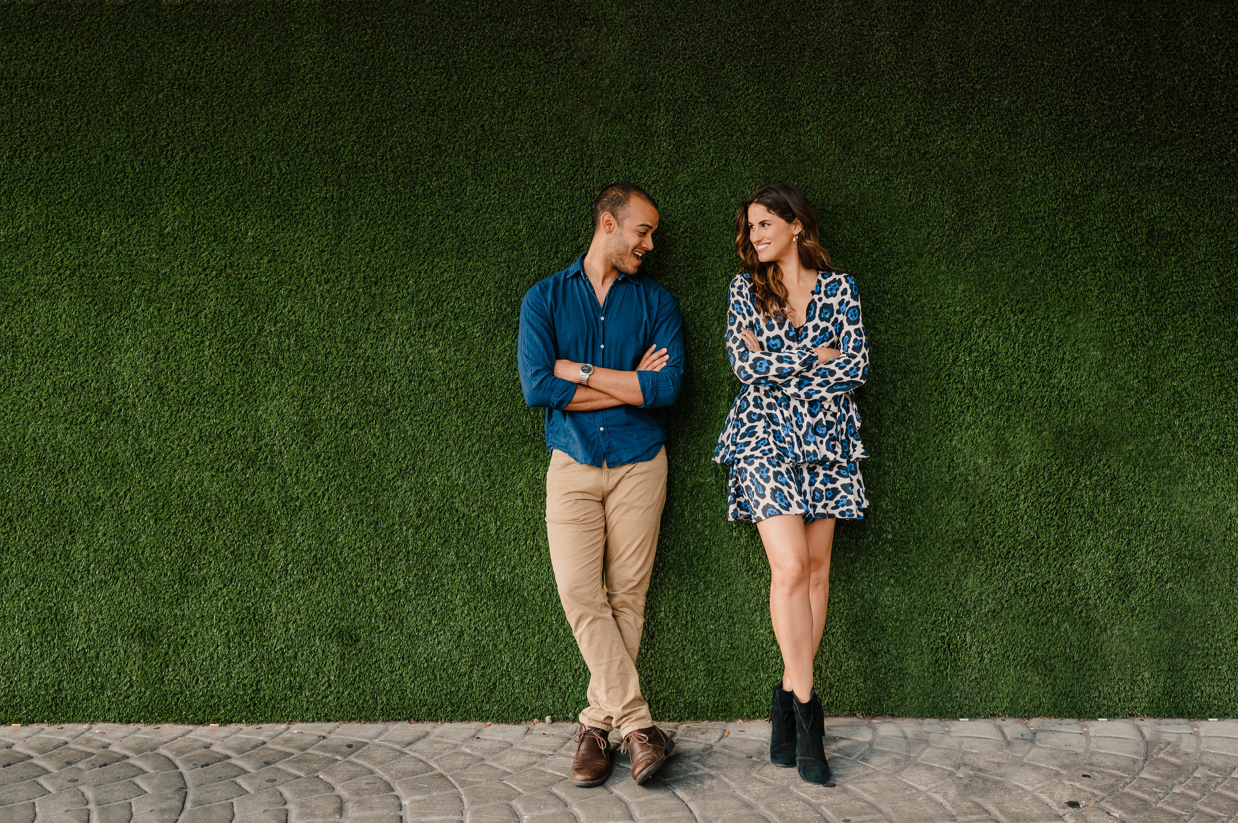  Andres and Rebecca posing in front of green wall in Downtown Tampa Florida 