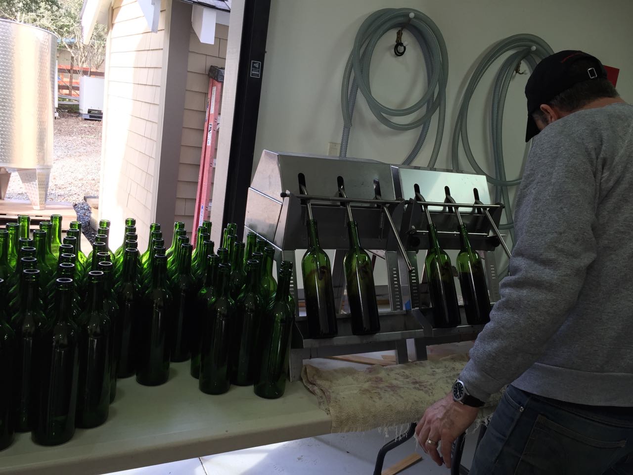 New bottles are placed in filler(wine is fed into filler by gravity with no pumping)