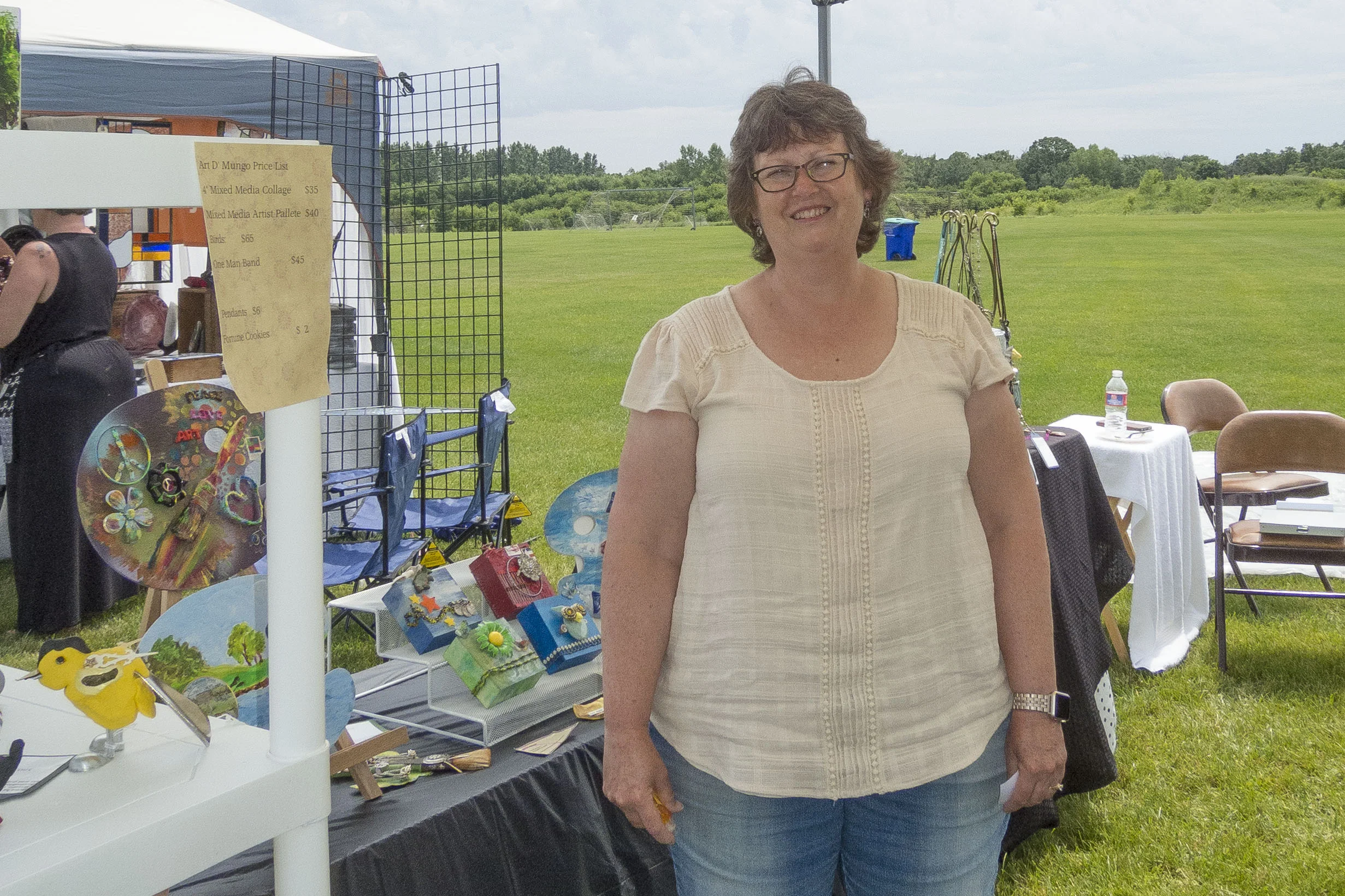 Lori Norman shows off her booth