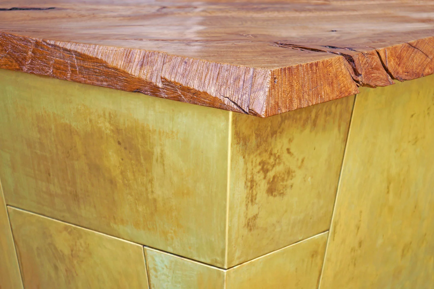  patinated brass panels and salvaged white oak top with chainsaw marks from the logger left intact  