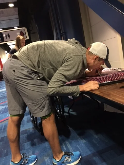 Signing the surf board that went to President Obama at the Whitehouse visit after the games. 