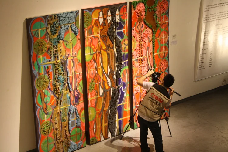 Camera man standing in front of Xiangqi: “A Game for Evolution” at the “OrientAsian” Show in J&amp;Z Gallery