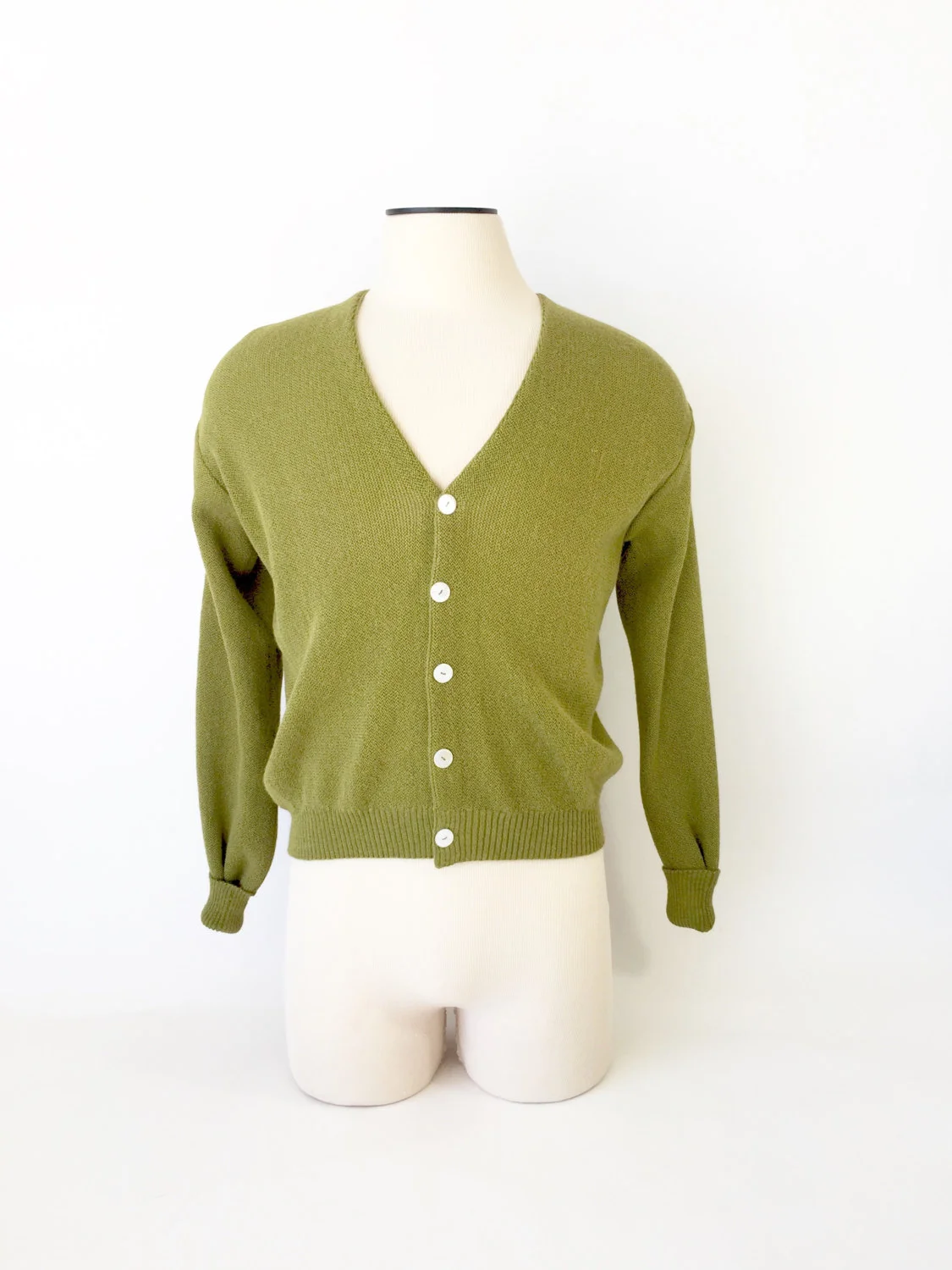 Awesome green boucle cardigan sweater circa 1960s. Great shell buttons and a classic staple in most men's wardrobes of the era..