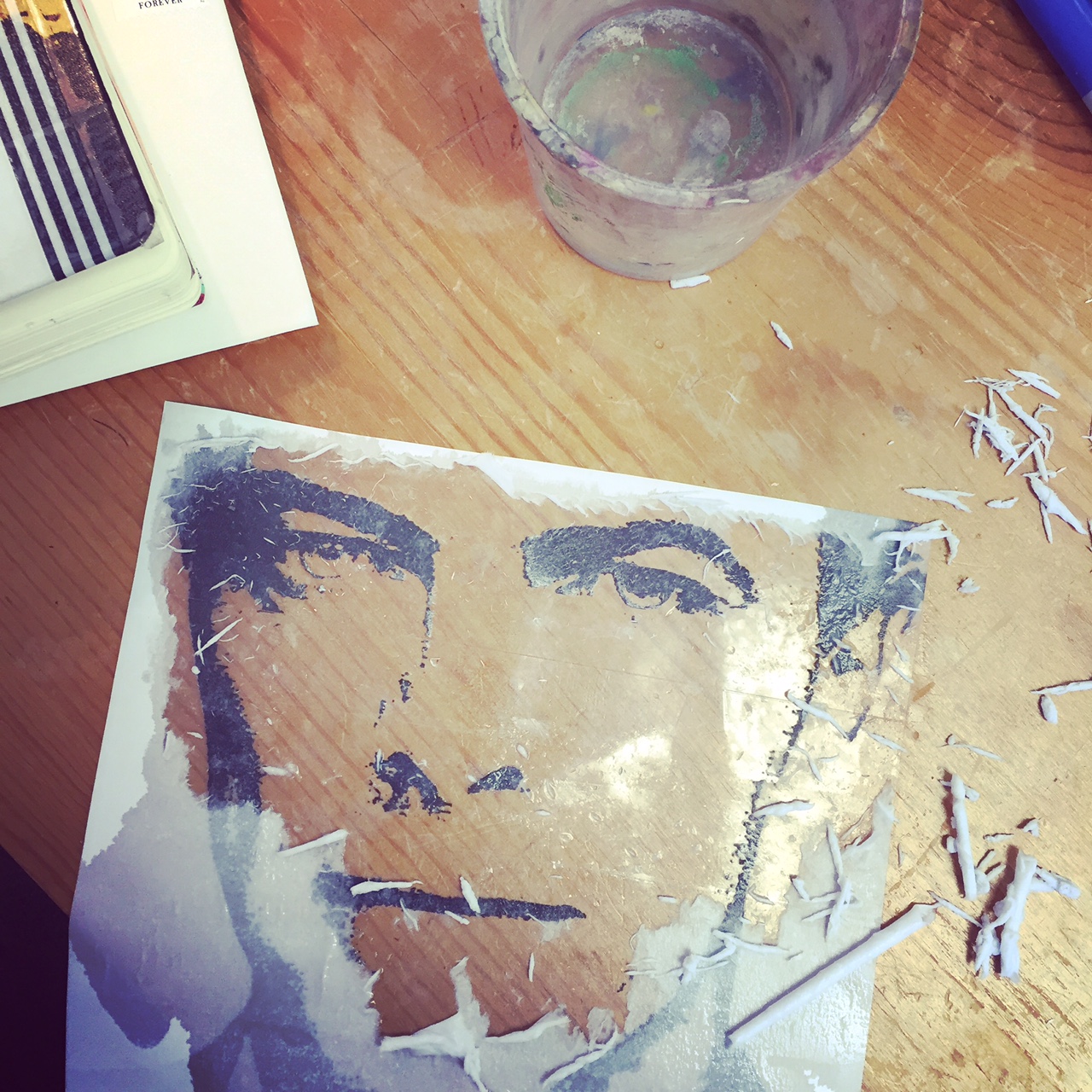 The next step was to create the image transfer. I applied packaging tape to the image overlapping as I went to create a tight seal. Then carefully dampened the exposed paper remaining on the back with water and began the gently removal process. 