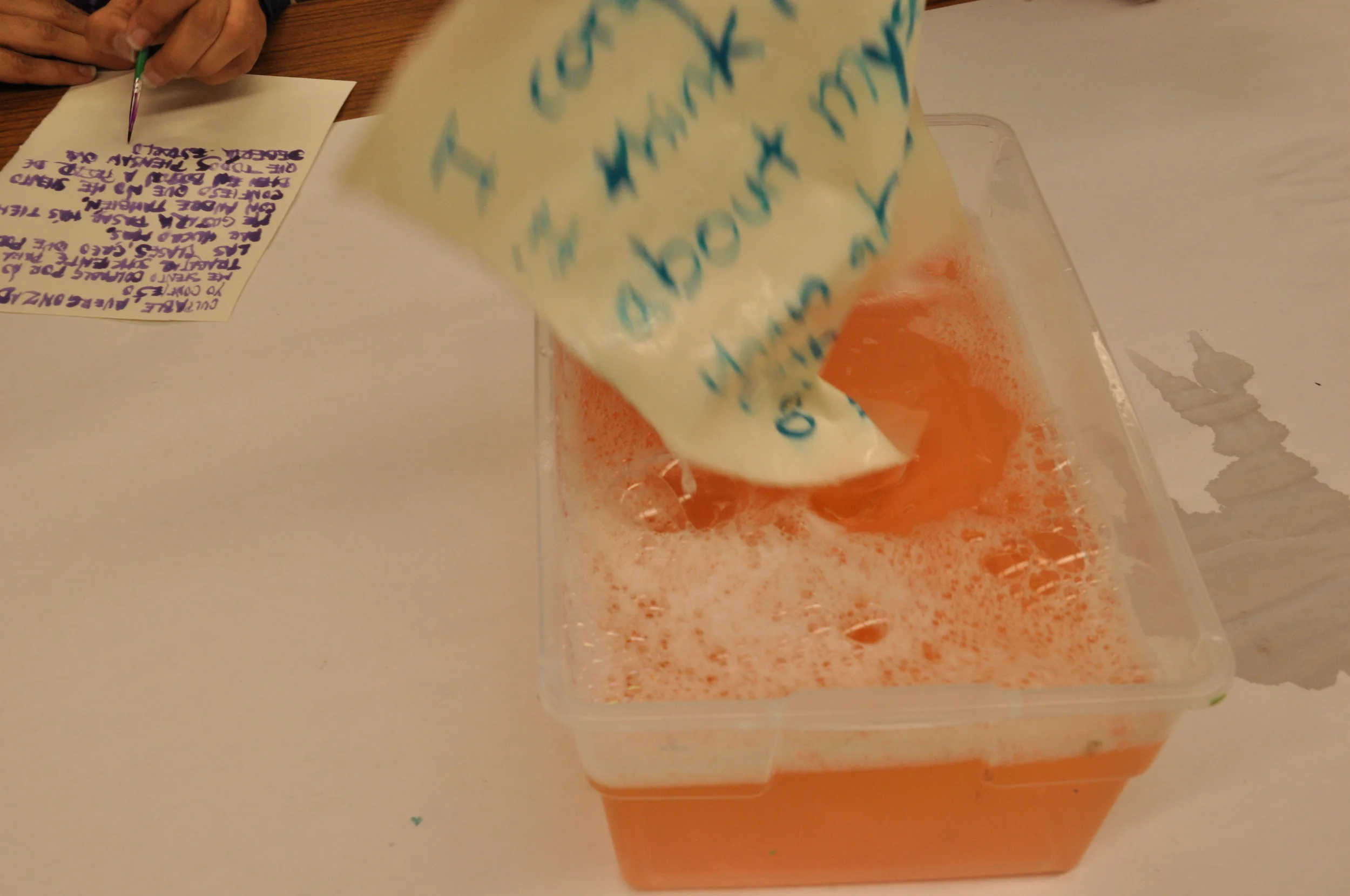  In order clean their minds from those experiences, they wash the confessions away with the help of a sponge and a bucket filled with clean water. This part of the workshop is completed by the entire audience at the same time in order to create a mor