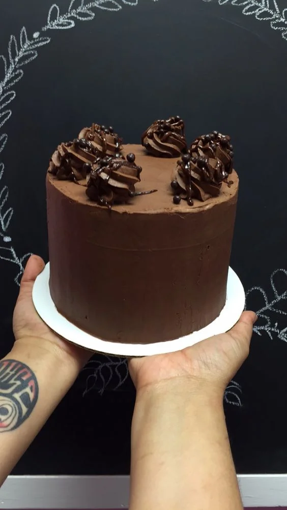 Chocolate Wasted - 3 layers of chocolate cake filled and frosted with whipped chocolate ganache. topped with chocolate ganache and chocolate rice crisps. 6 inch $40 8 inch $50