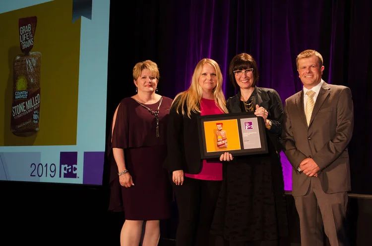 Karen Tsoutos, Marketing Brand and Graphics Manager at Weston, and Sara Merrifield, VP Account Director at Davis, accepted the award for Country Harvest’s redesign.