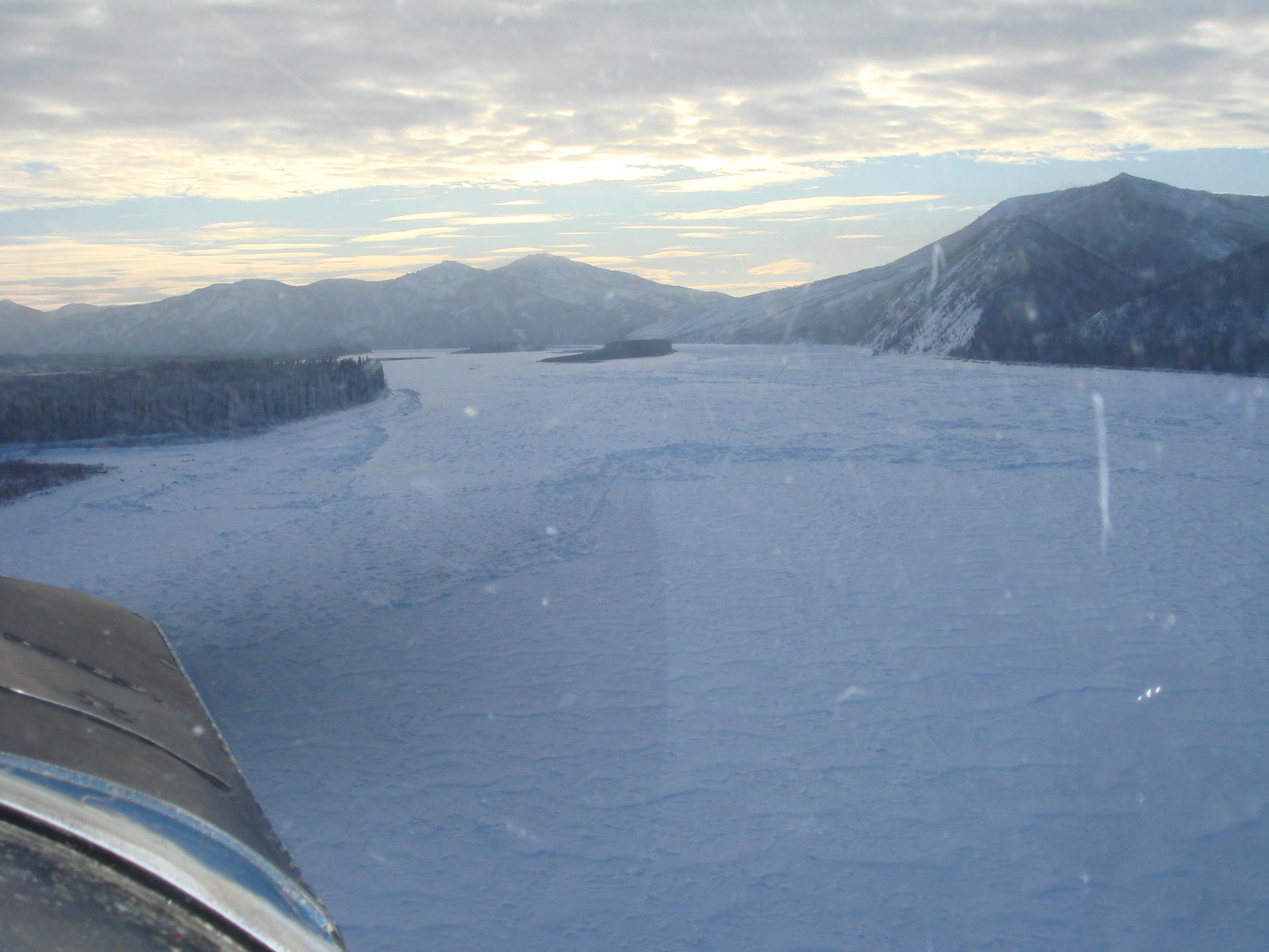 Trout Creek behind the island in the top center of the picture. The trail crosses from right to left by the island, then up the river on the left side of this photo. Jumble ice evident.