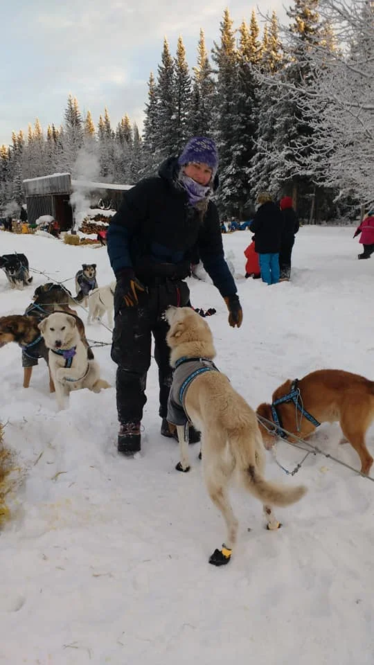 Ryne taking care of her dogs just after arriving at the first checkpoint.