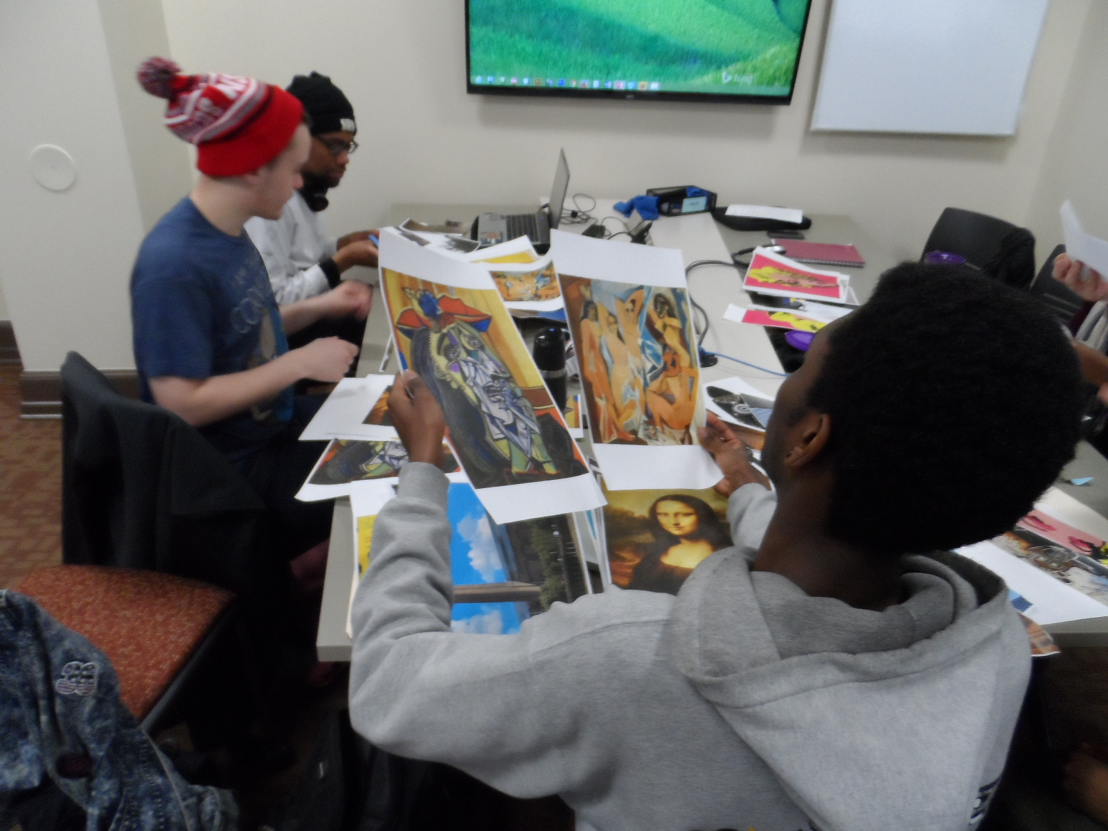 This student compares two works from Picasso, "The Crying Woman" in the left hand and "Les Demoiselle d'Avignon" in the right hand as Leonardo da Vinci's Mona Lisa lay on the table adjacent to an image of the Tate Modern in London. All referenced in Jay Z's song "Picasso Baby".