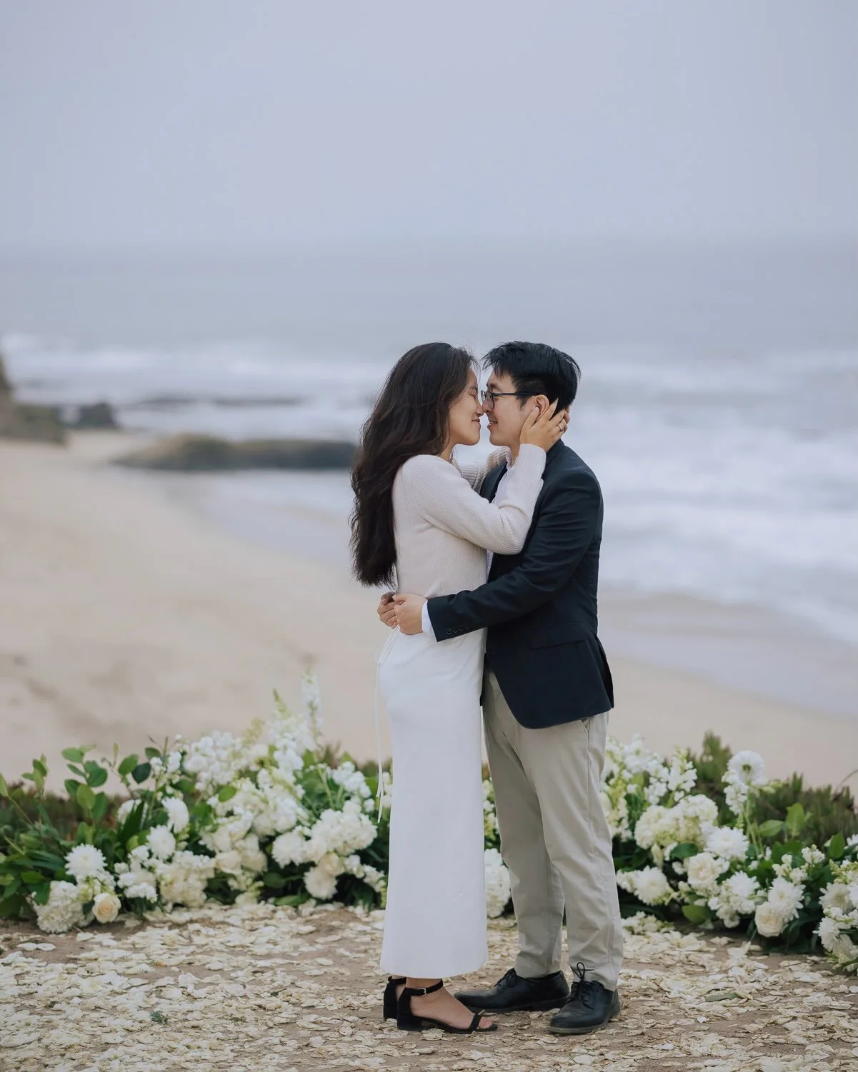 The fog crept up the cliff,
and the wind made a mess of her hair.
He got down on one knee,
before he&rsquo;d said a word,
and she was already laughing too hard to answer.
Everything else had blurred into fog and salt air,
and all that stayed sharp
wa