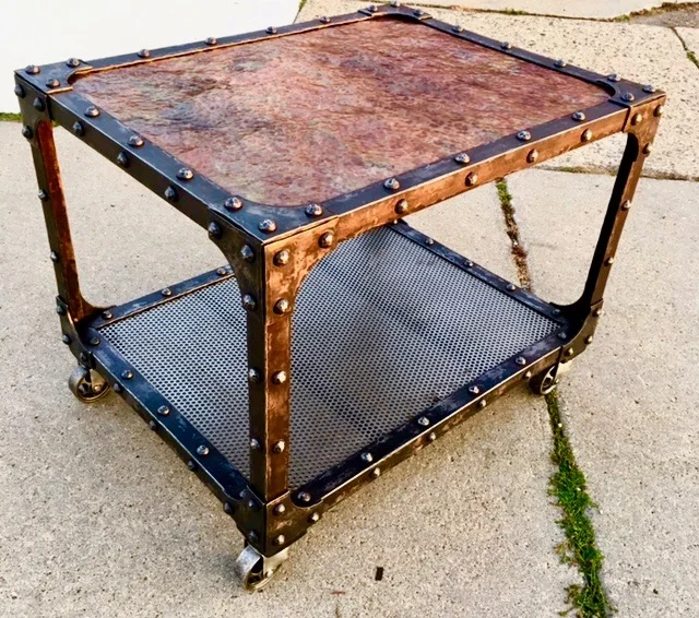 Hammered copper top, textured angle iron frame, perforated steel shelf & hand forged rivets, vintage casters... oil & wax. 