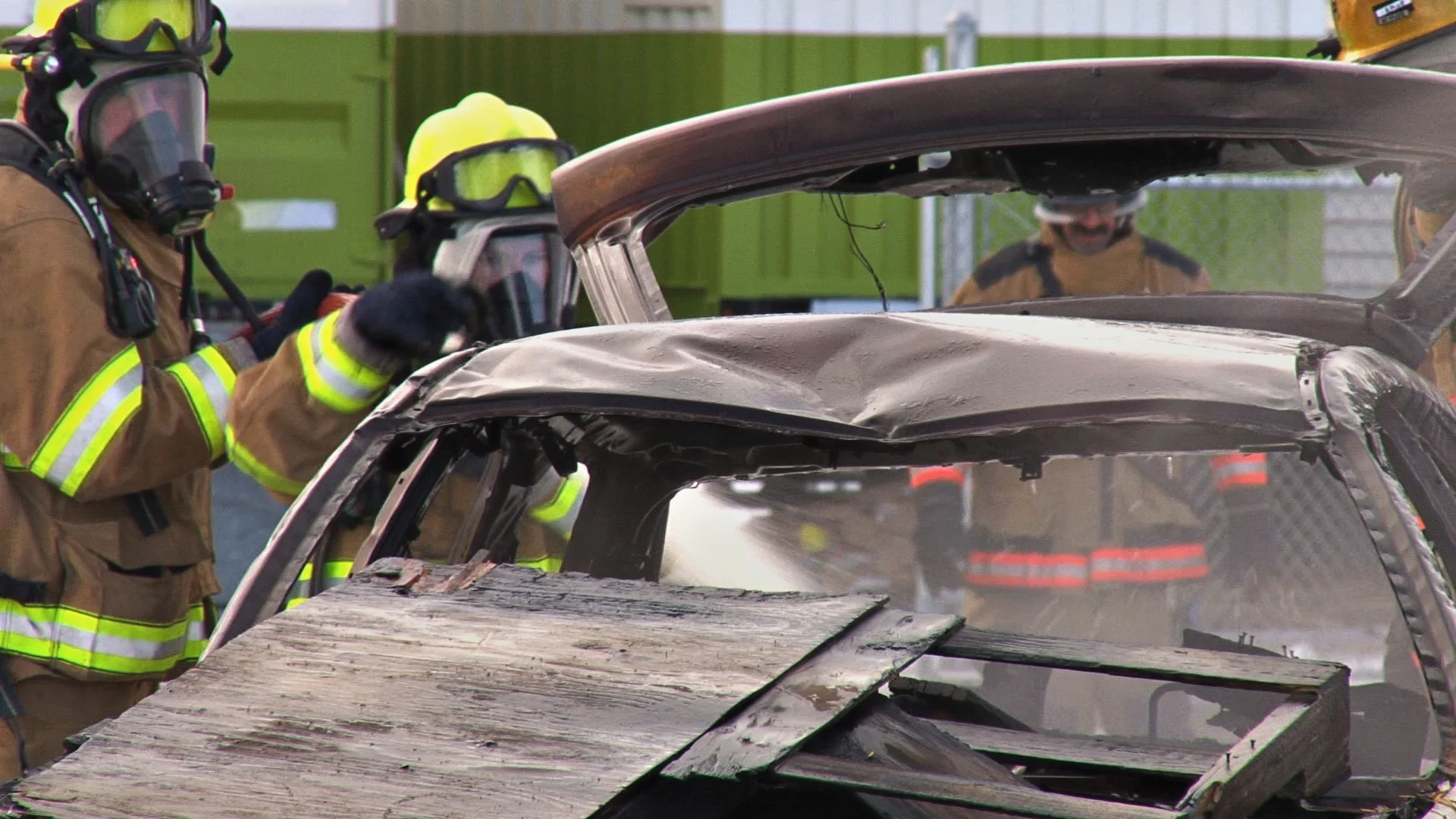 100212-FirefightersDousingBurntWreckageofCar.jpg