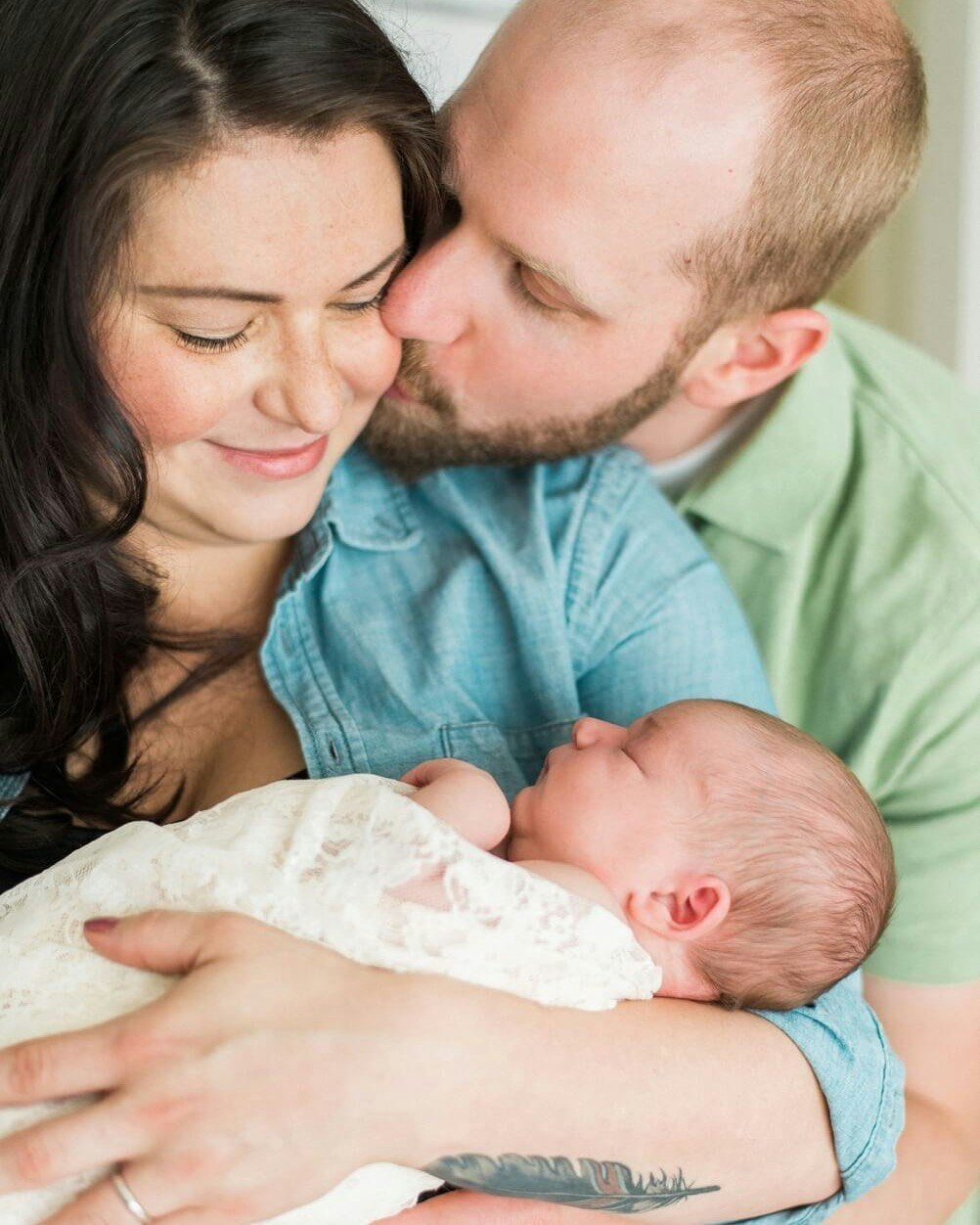 A sweet little captured moment between these two new parents. What a blessing this little baby girl is.