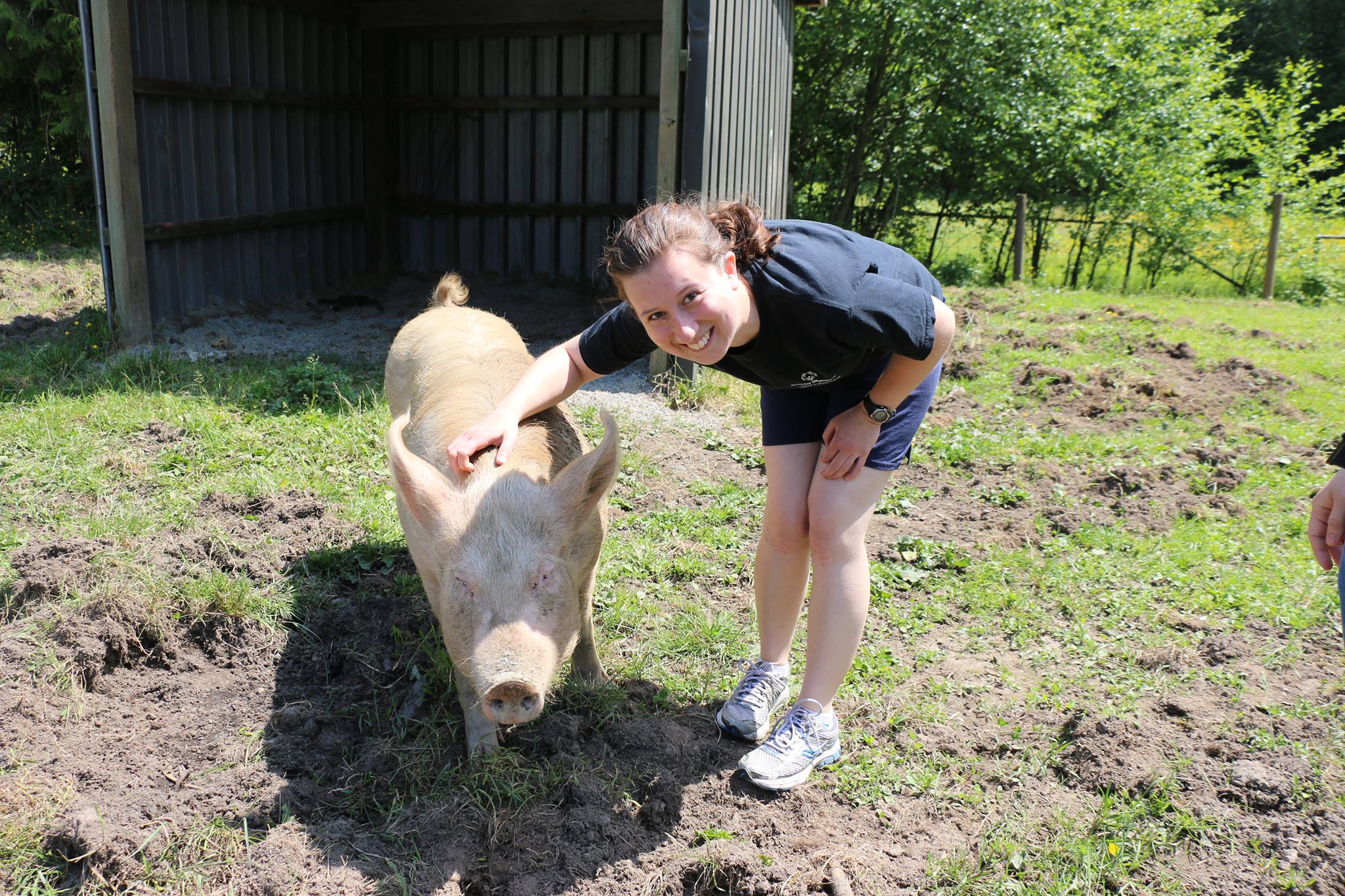 Almira with Lucy, a rescued pig, at The Happy Herd sanctuary.