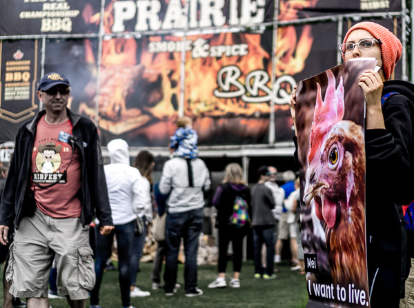 Activist holding a banner at a BBQ cooking competition 