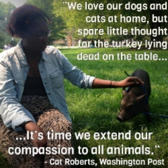 Cat Roberts petting a pig and sharing her views on animal liberation.