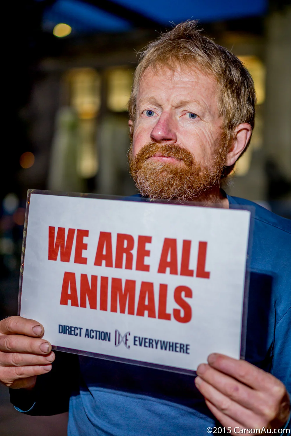 Stephen, an activist from Vancouver, holds up a "We Are All Animals" placard.