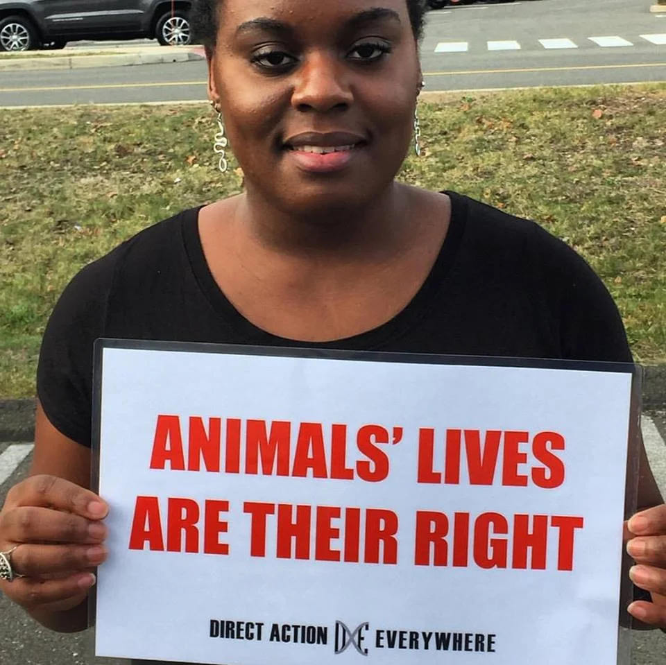 Tiffany holding a sign that says "Animals' Lives Are Their Right"